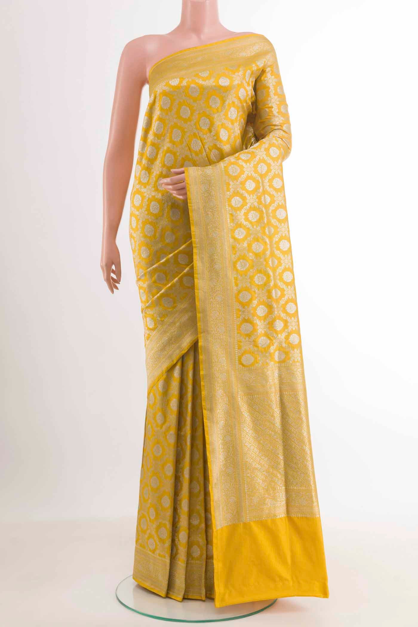 Yellow Banarasi Silk Saree with Zari Brocade on the body and Zari Border.  displayed on a mannequin