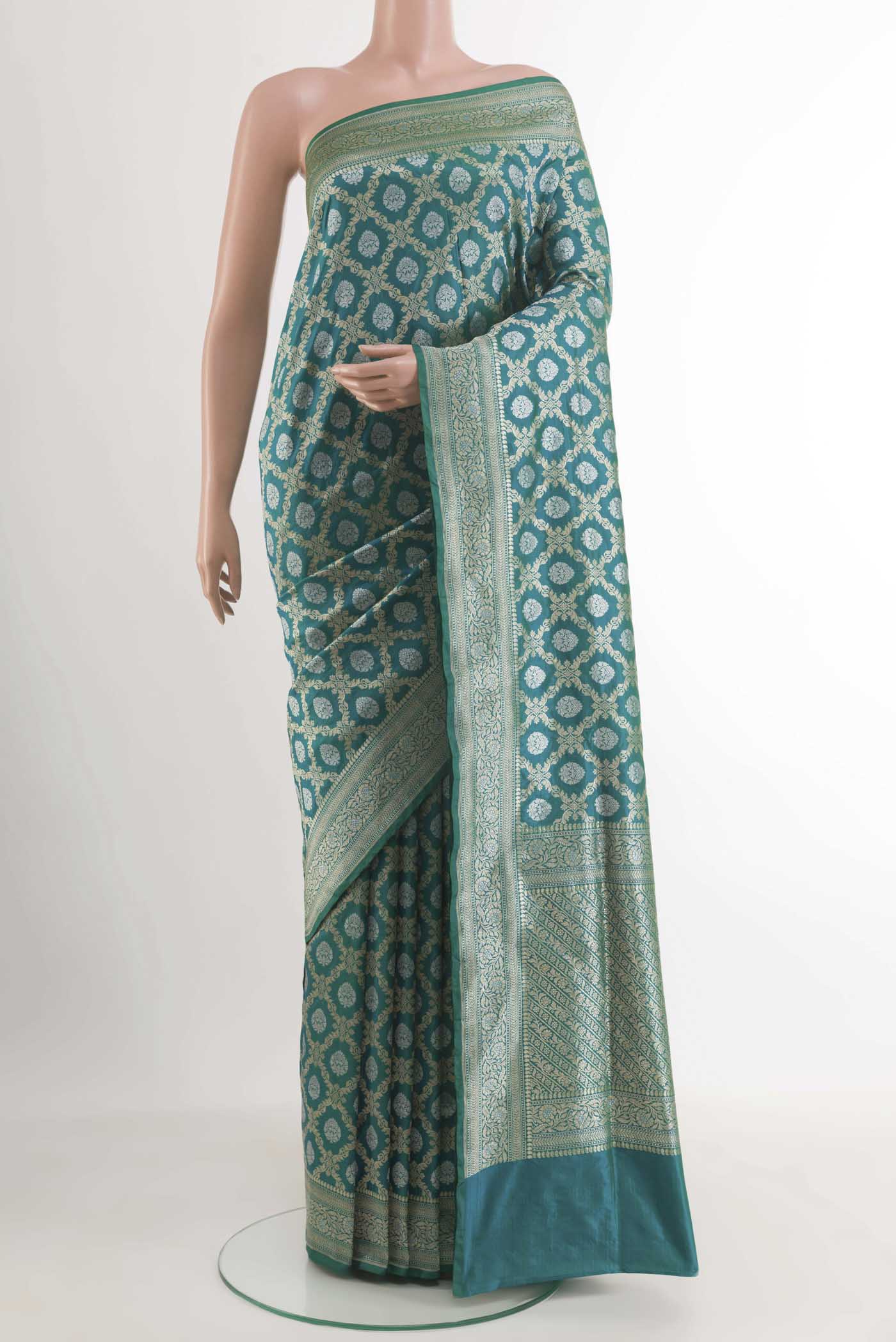 Teal Banarasi Silk Saree with Zari Butta on the body and Zari Border.  displayed on a mannequin