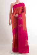 Brick Orange Kanjivaram Silk Saree with Zari Butta on the body and Zari Border.  displayed on a mannequin