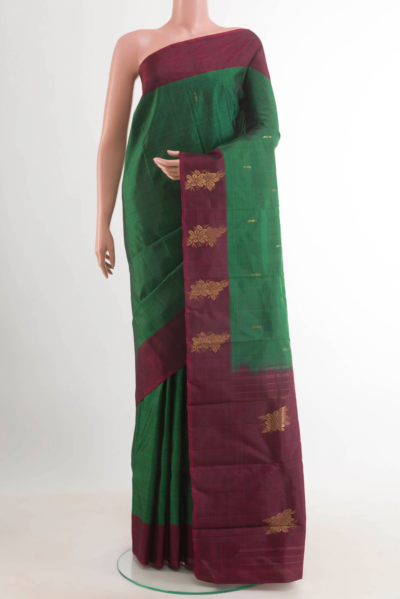 Bottle Green Kanjivaram Silk Saree with Zari Butta on the body and Zari Border.  displayed on a mannequin