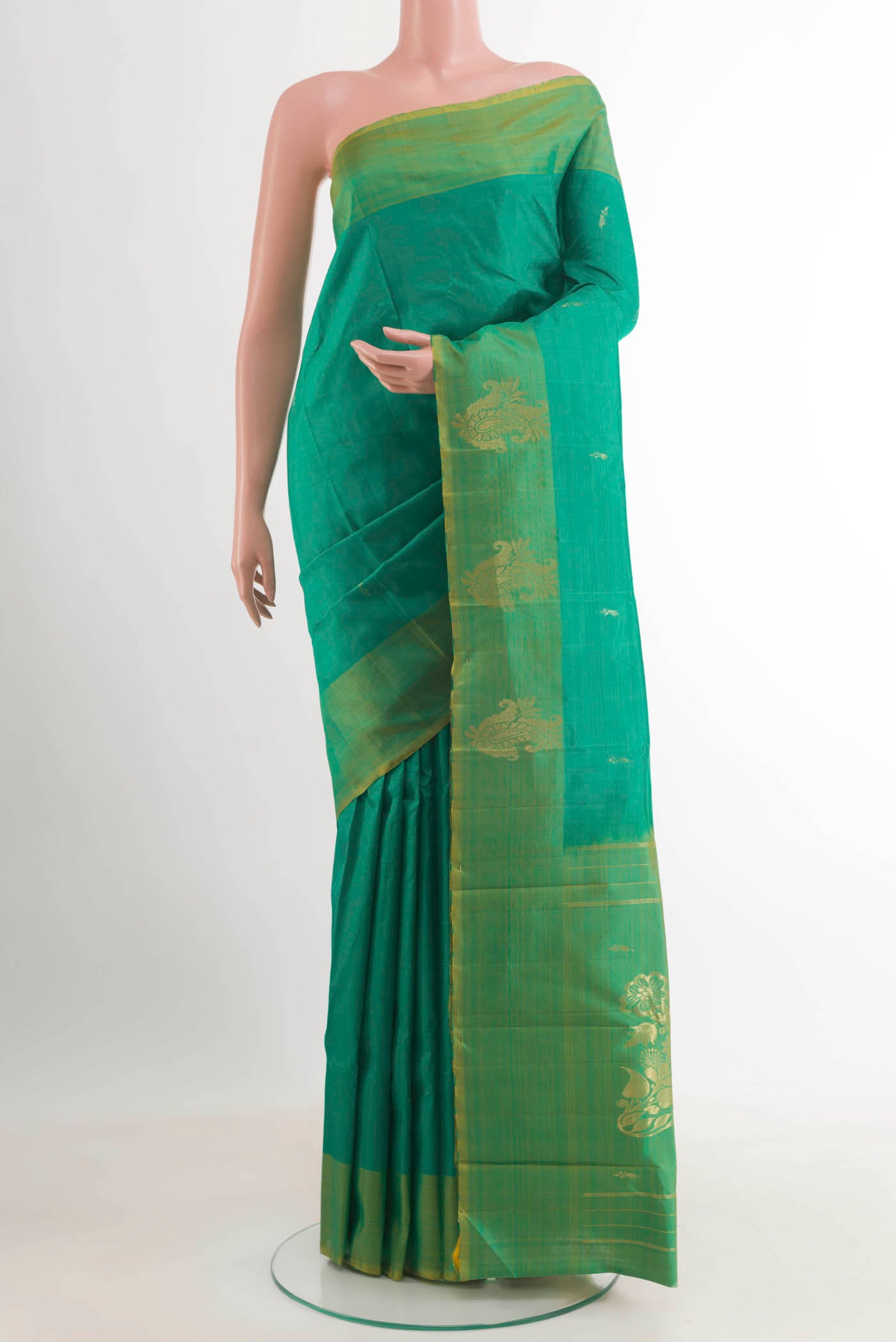 Green Kanjivaram Silk Saree with Zari Butta on the body and Zari Border.  displayed on a mannequin