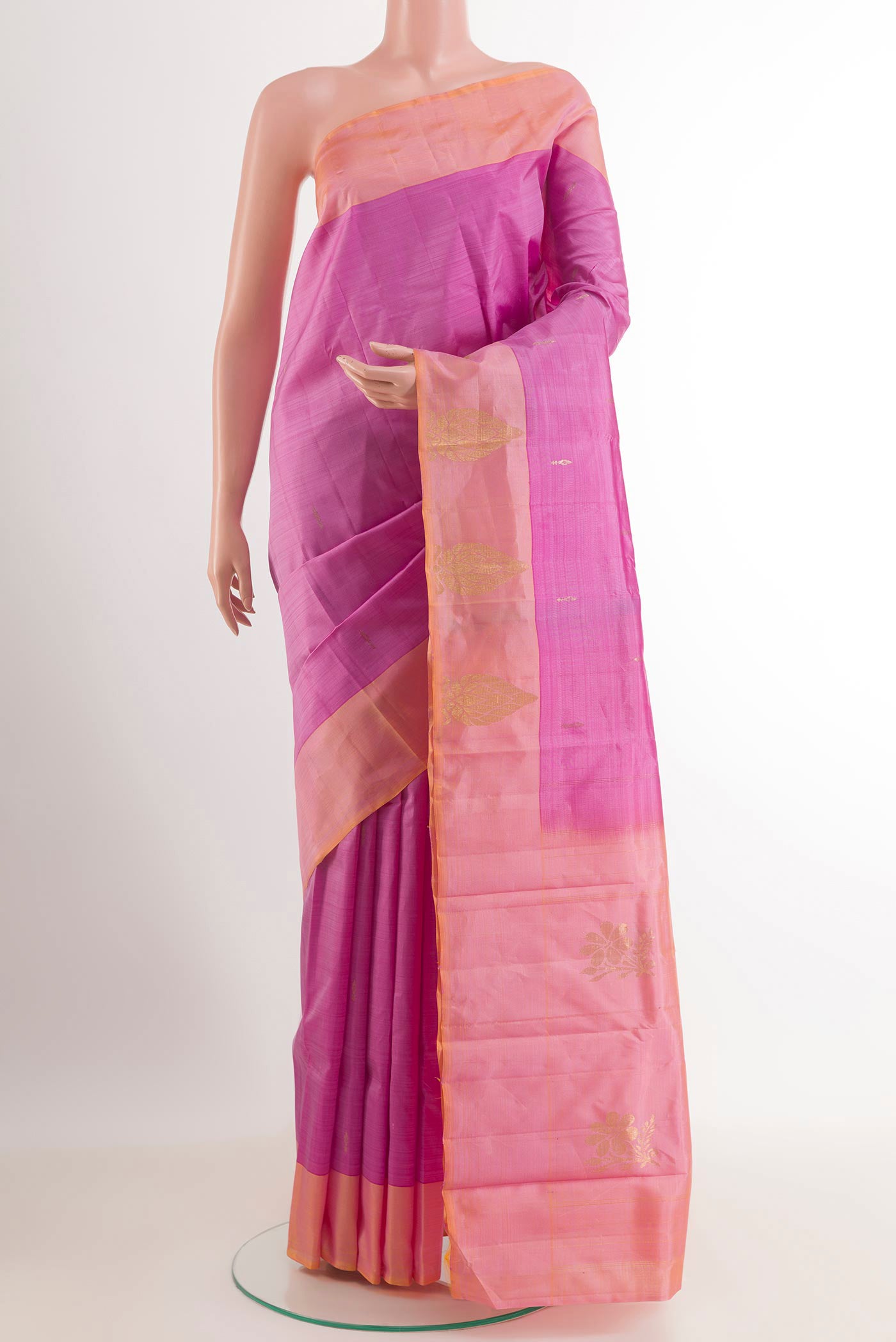 Pink Kanjivaram Silk Saree with Zari Butta on the body and Zari Border.  displayed on a mannequin