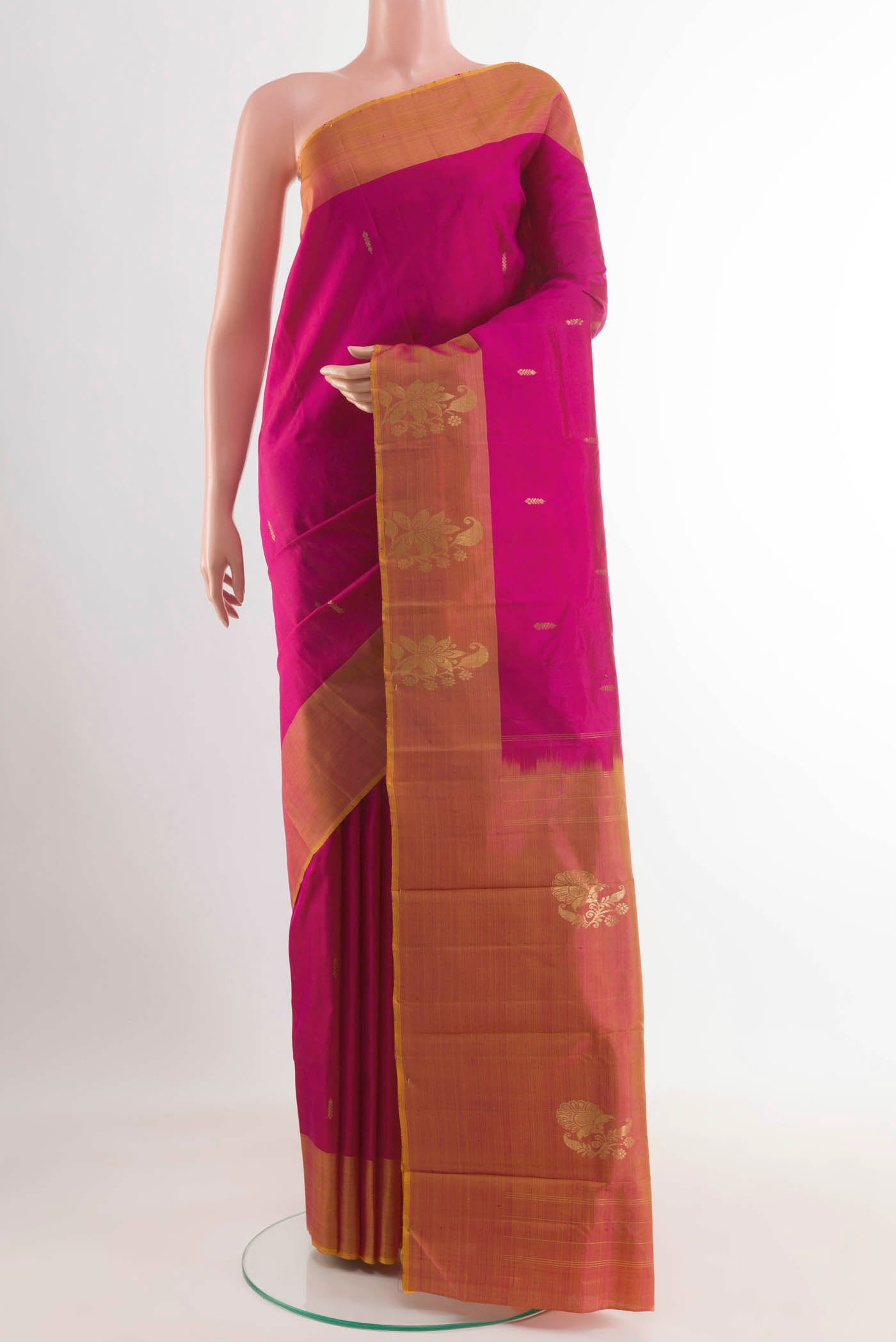 Rani Pink Kanjivaram Saree with Zari Butta on the body and Zari Border.  displayed on a mannequin
