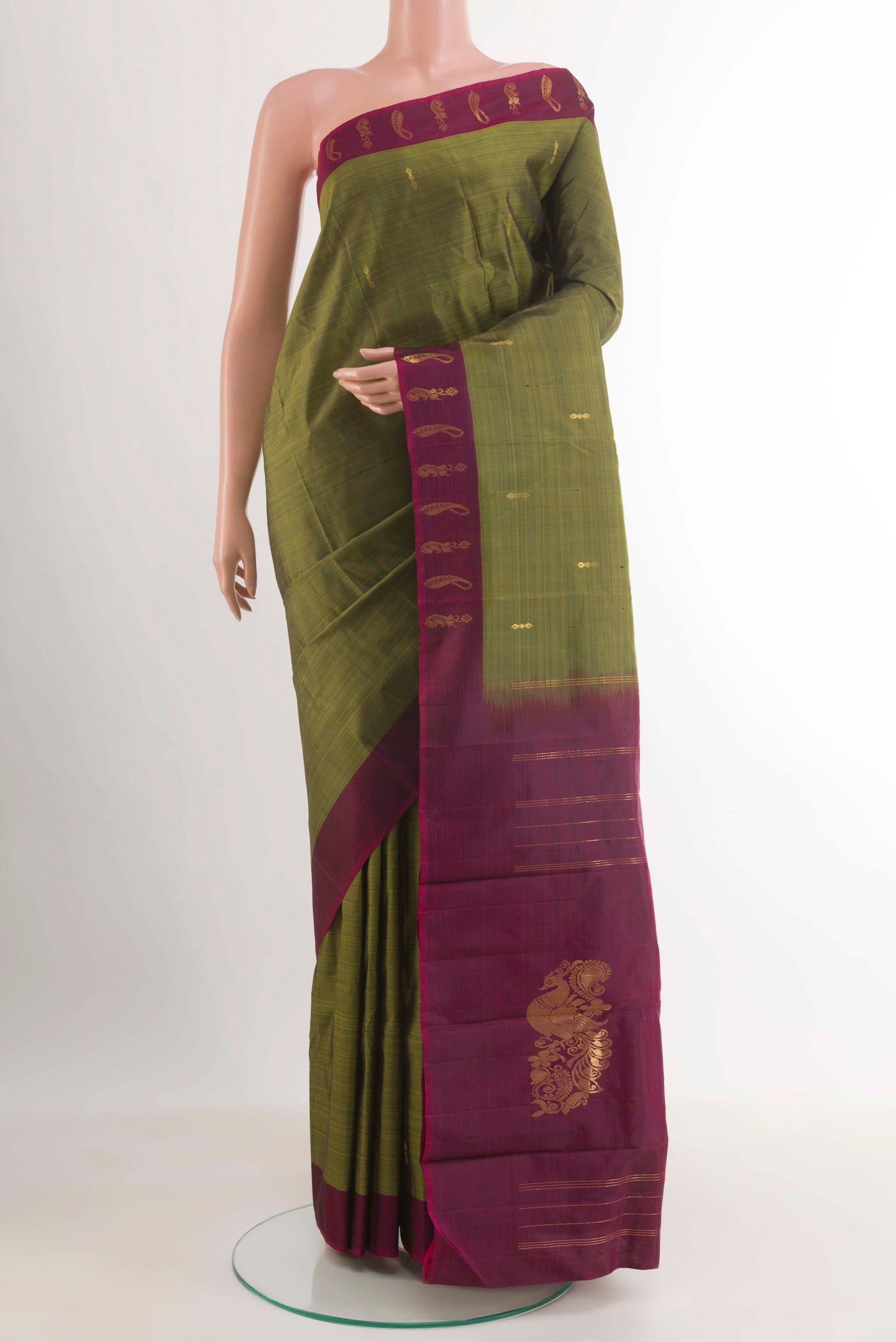Mehandi Green Kanchipuram Silk Saree with Zari Butta on the body and Zari Border.  displayed on a mannequin