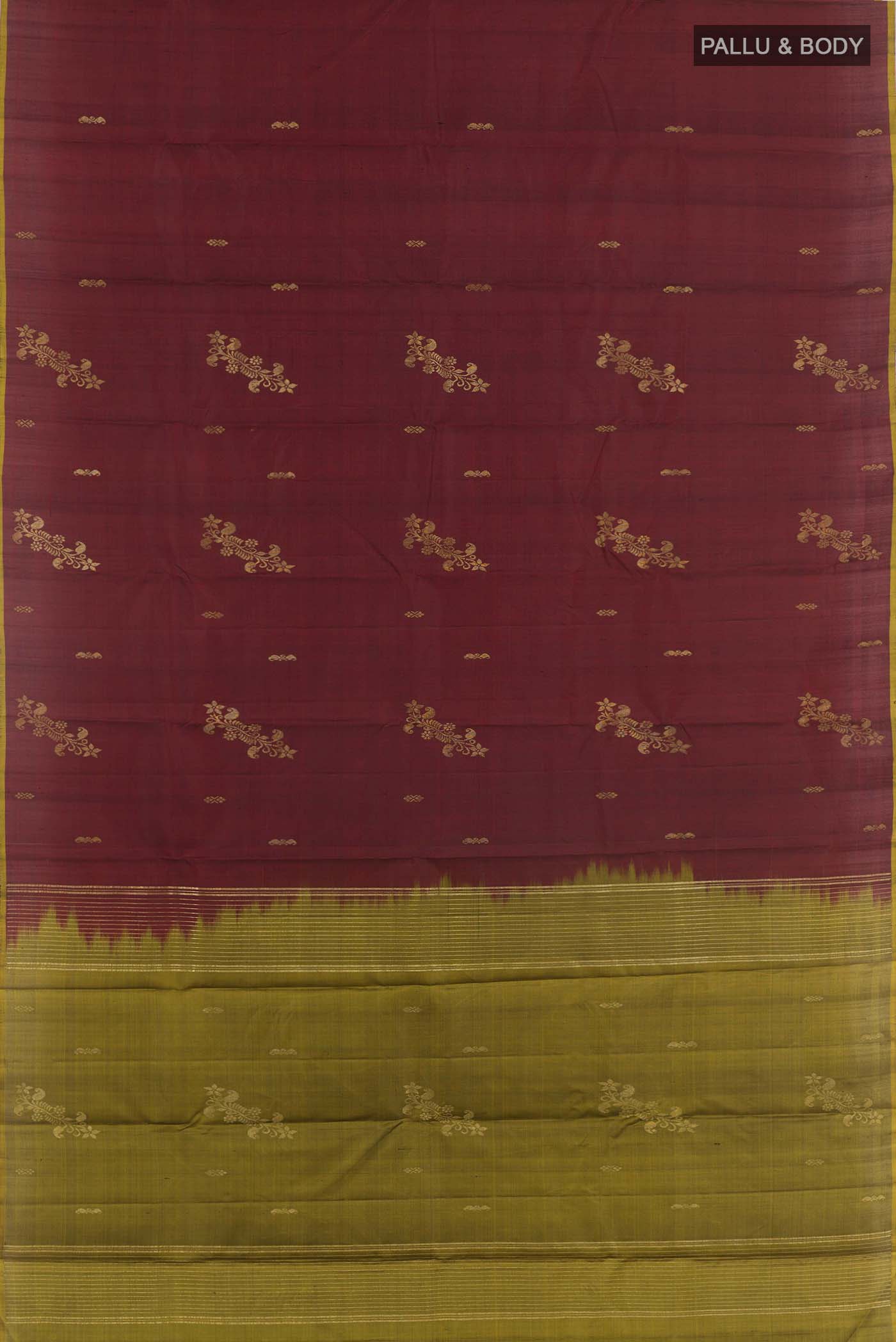 Flat view of Maroon Kanchipuram Silk Saree with Zari Butta on the body and Zari Border. 
