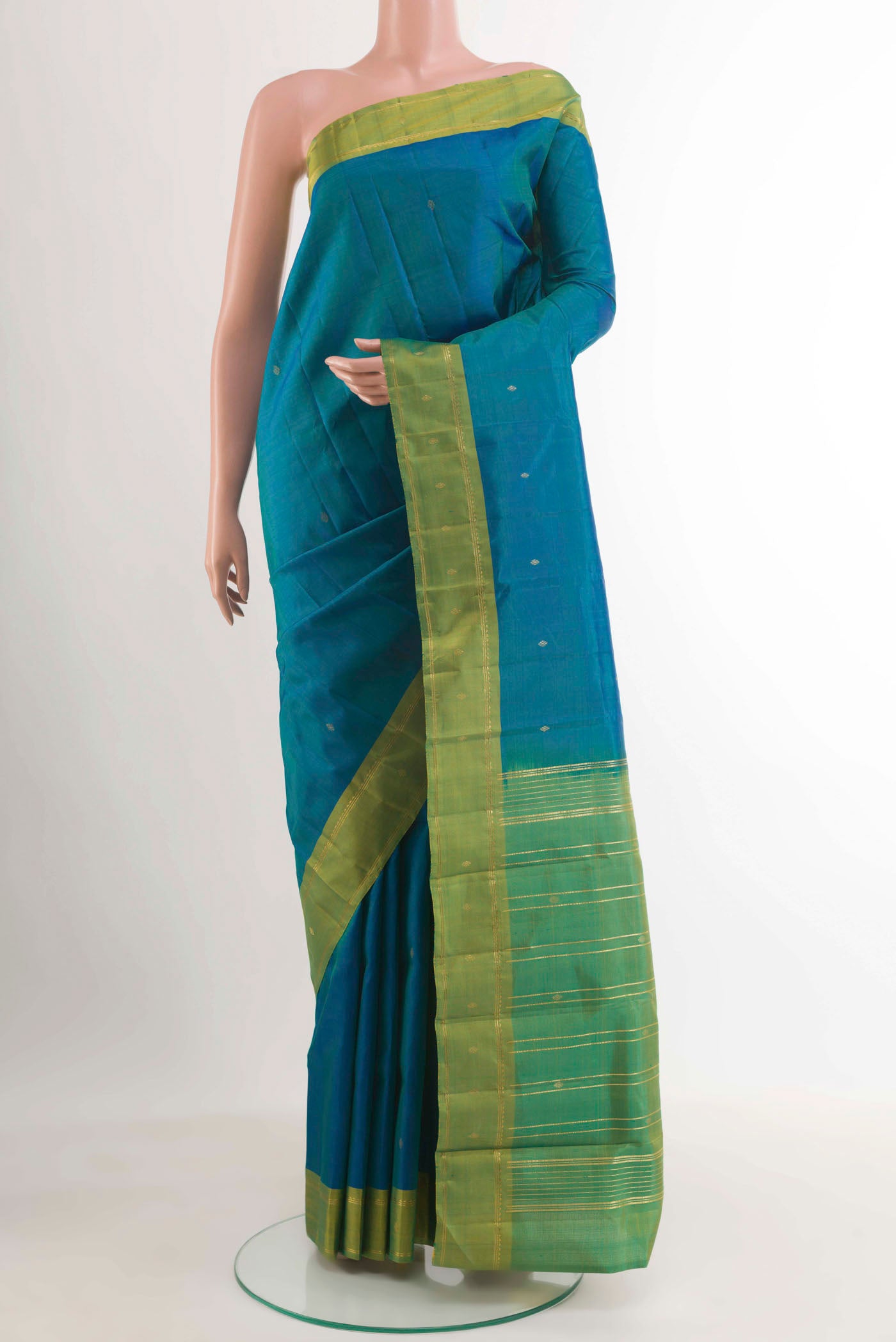 Peacock Blue Kanchipuram Silk Saree with Zari Butta on the body and Zari Border.  displayed on a mannequin