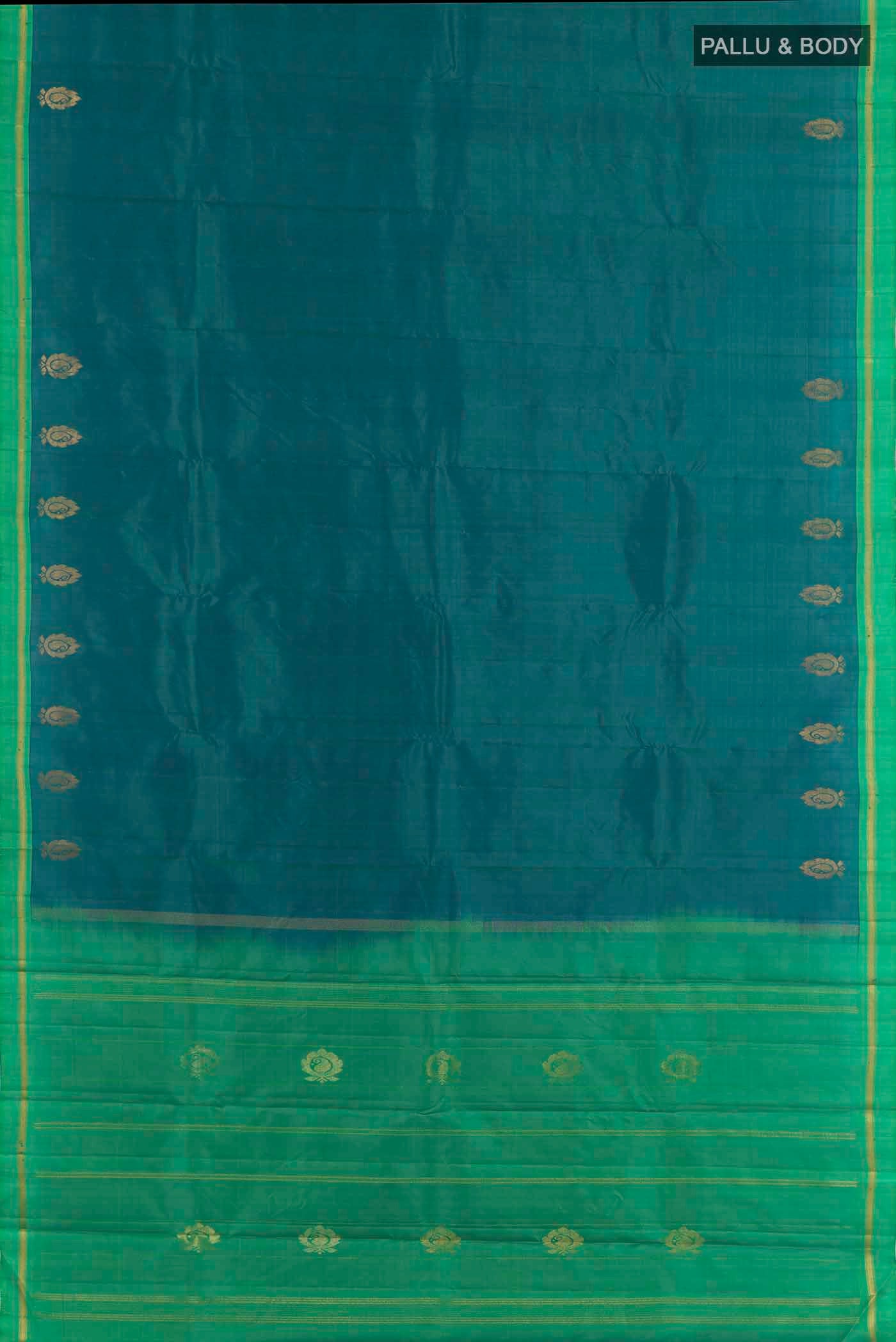 Flat view of Peacock Blue Dual Tone Kanchipuram Silk Saree with Zari Butta on the body and Zari Border. 