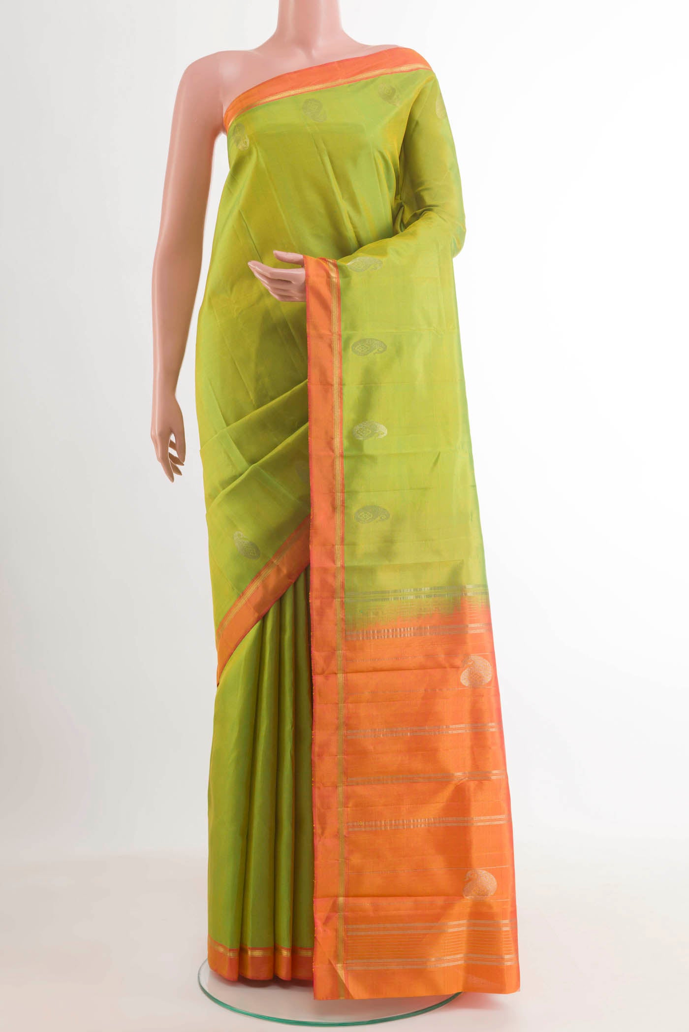 Green Kanchipuram Silk Saree with Zari Butta on the body and Zari Border.  displayed on a mannequin