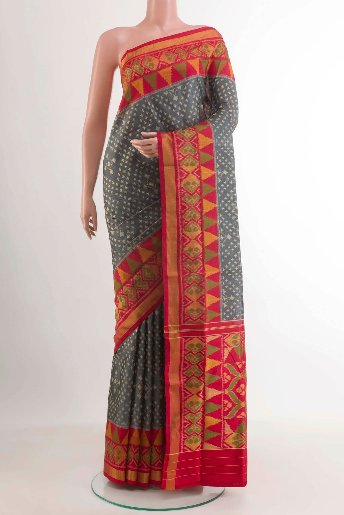 Grey Rajkot Patola Silk Saree with Ikat design on the body and Zari Border.  displayed on a mannequin
