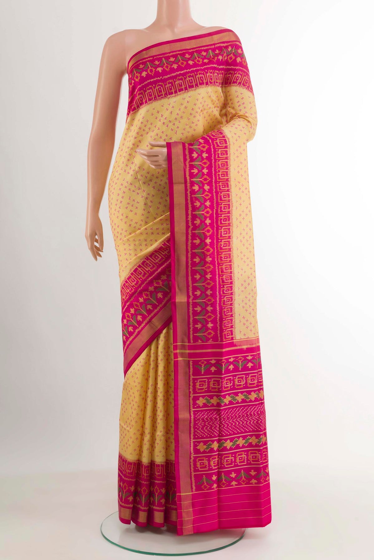 Lemon Yellow Rajkot Patola Silk Saree with Ikat design on the body and Zari Border.  displayed on a mannequin