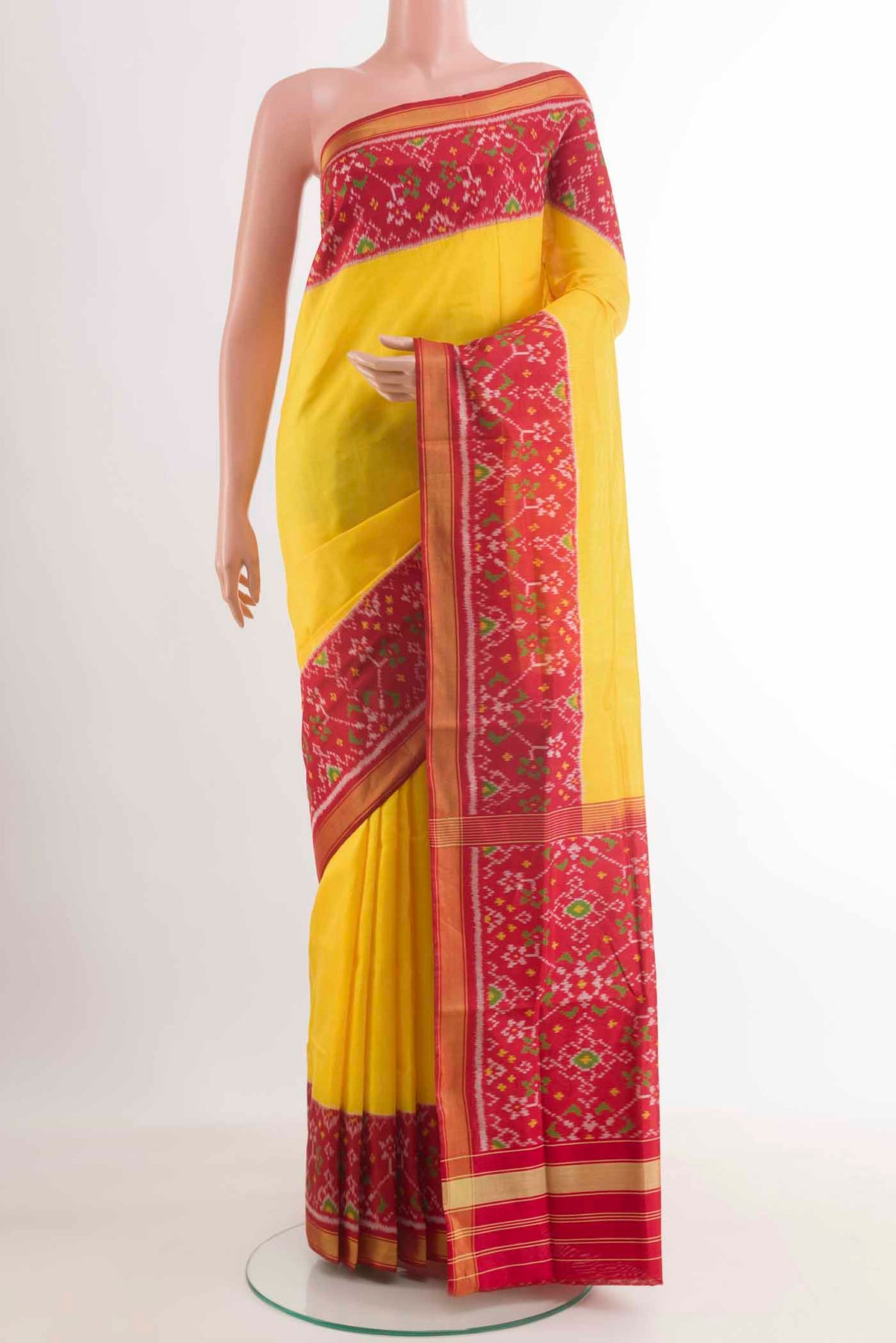 Yellow Rajkot Patola Silk Saree with Pure Ikat on the body and Zari Border.  displayed on a mannequin