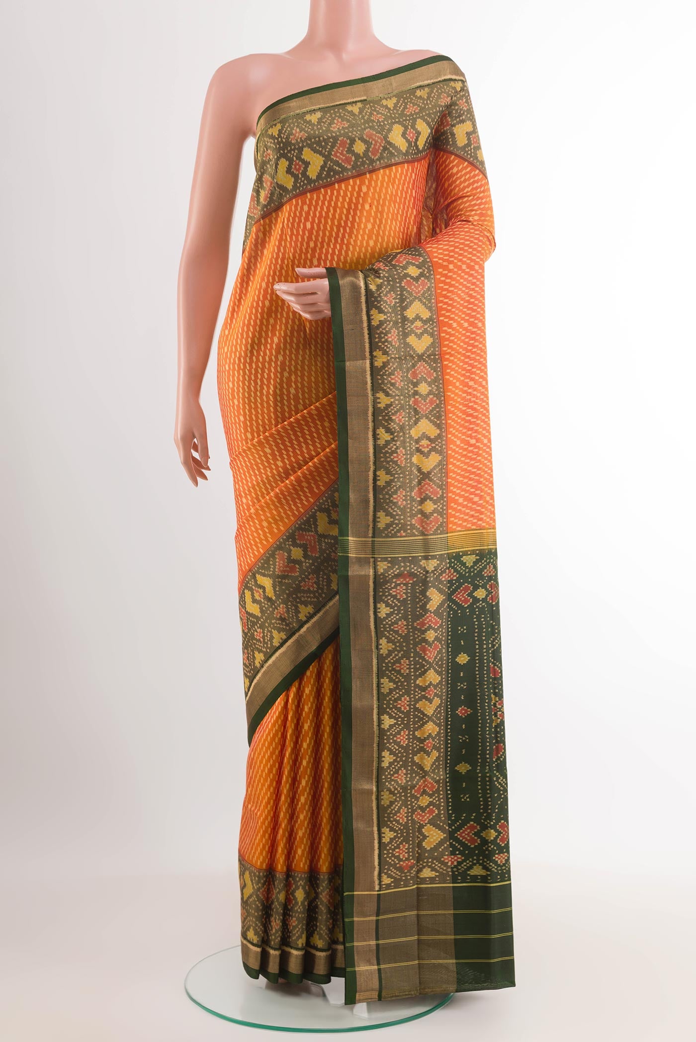 Yellow Rajkot Patola Silk Saree with Ikat design on the body and Zari Border.  displayed on a mannequin