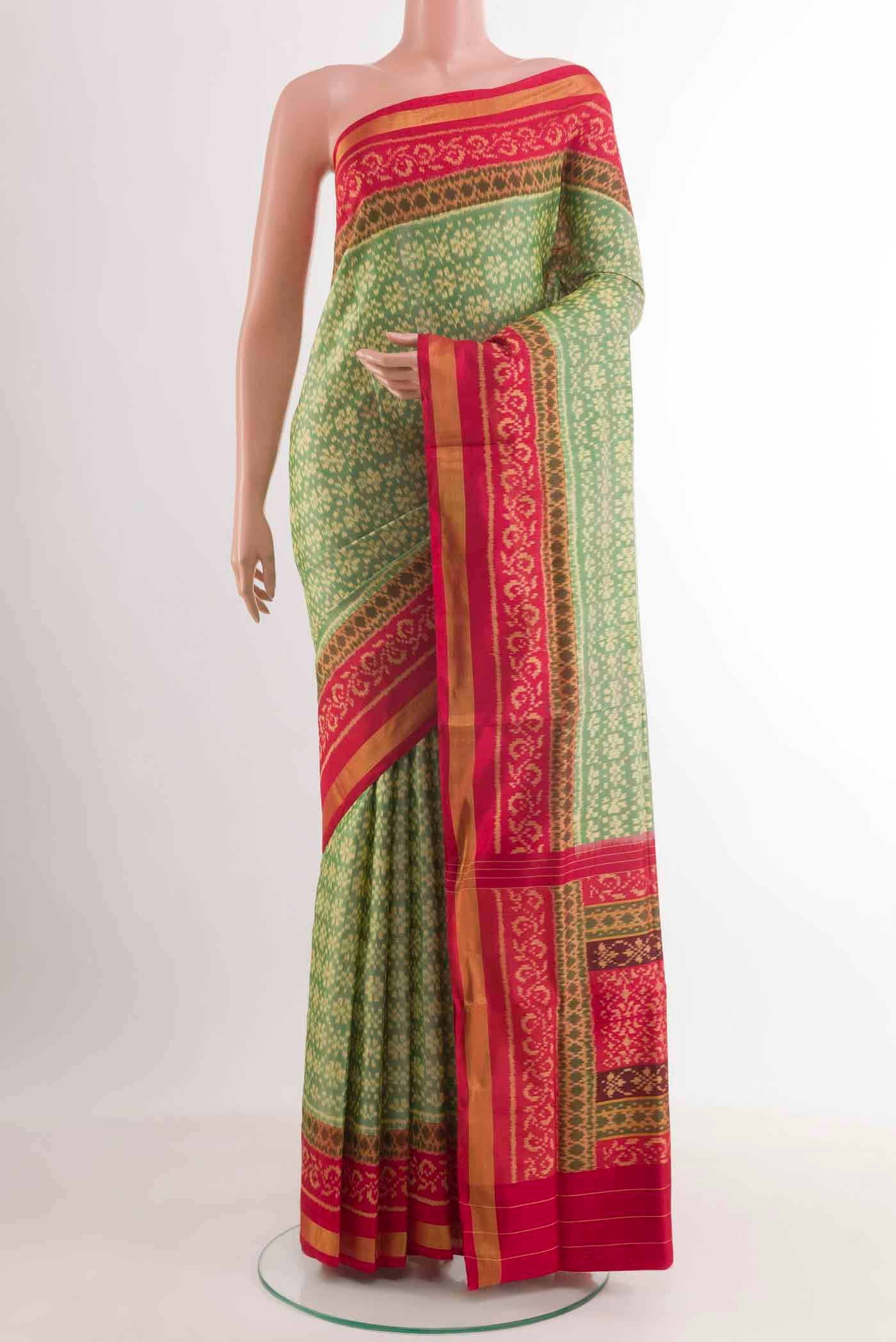 Green Rajkot Patola Silk Saree with Pure Ikat on the body and Zari Border.  displayed on a mannequin