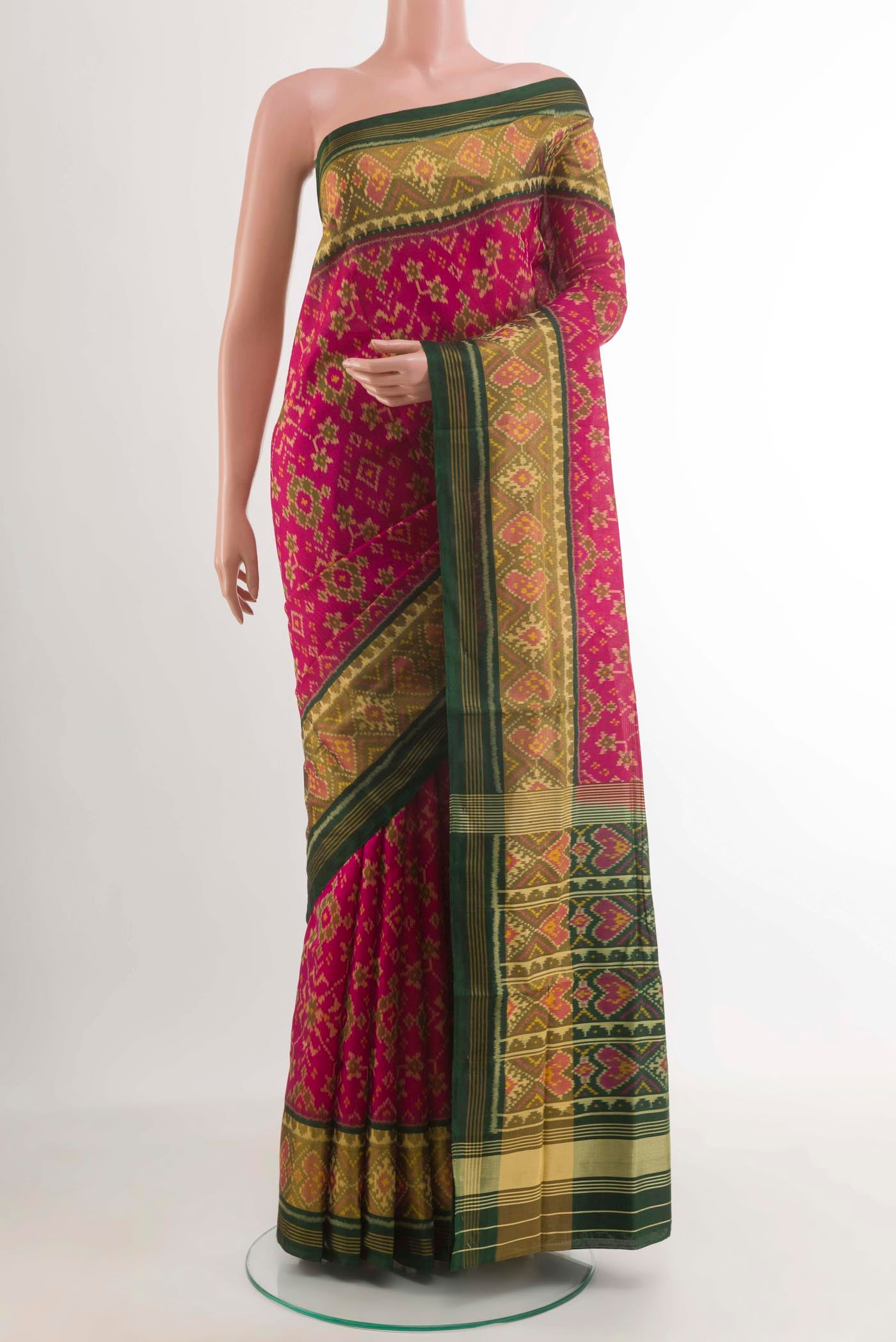 Pink Rajkot Patola Silk Saree with Ikat design on the body and Zari Border.  displayed on a mannequin