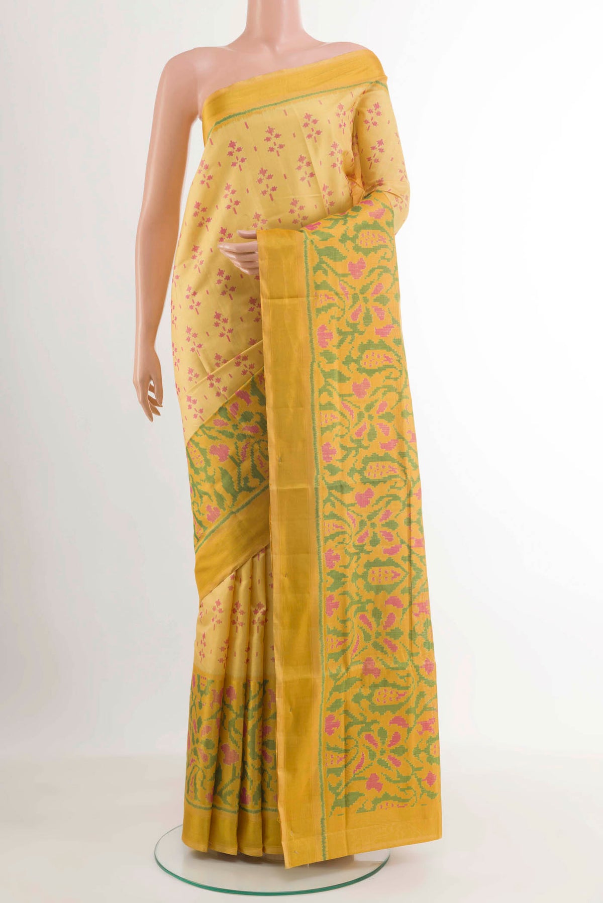 Yellow Rajkot Patola Silk Saree with Ikat design on the body and Zari Border.  displayed on a mannequin
