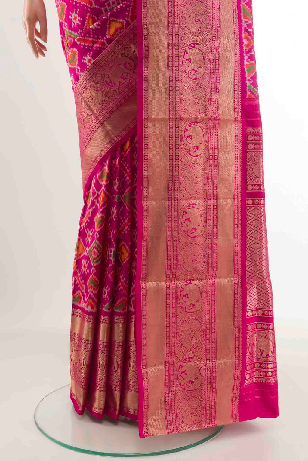 Pleats and pallu of Rani Pink Rajkot Patola Silk Saree with Pure Ikat on the body and Zari Border. 