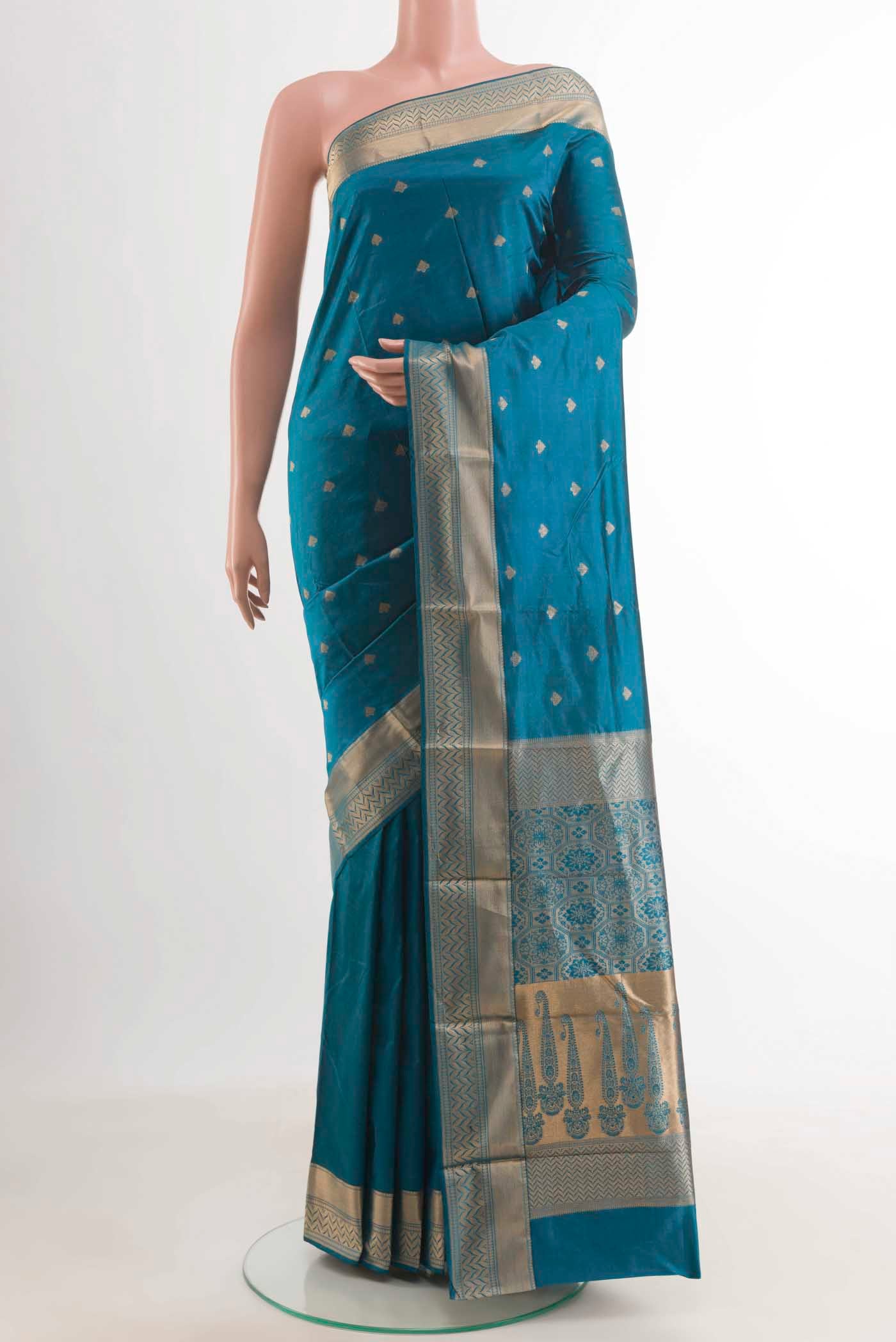 Royal Blue Kanjivaram Silk Saree with Zari Butta on the body and Zari Border.  displayed on a mannequin