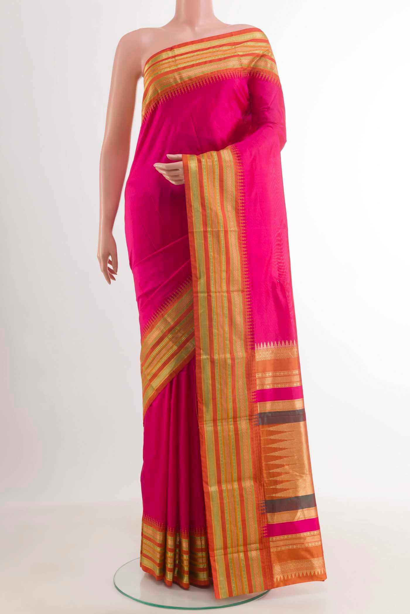 Pink Kanjivaram Silk Saree with Plain Body and Zari Border.  displayed on a mannequin