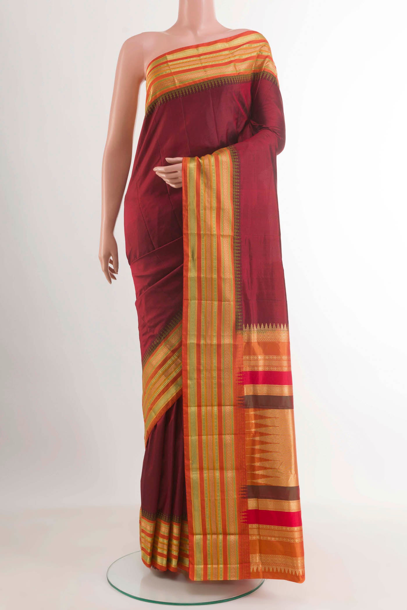 Maroon Kanjivaram Silk Saree with Plain Body and Zari Border.  displayed on a mannequin
