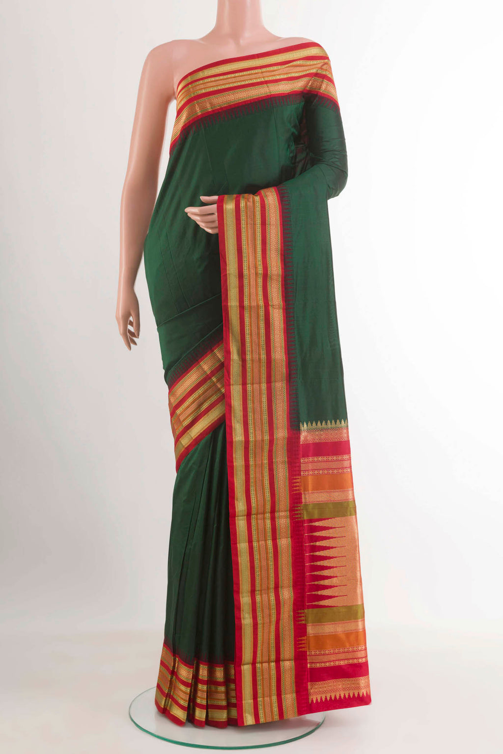 Bottle Green Kanjivaram Silk Saree with Zari Butta on the body and Zari Border.  displayed on a mannequin