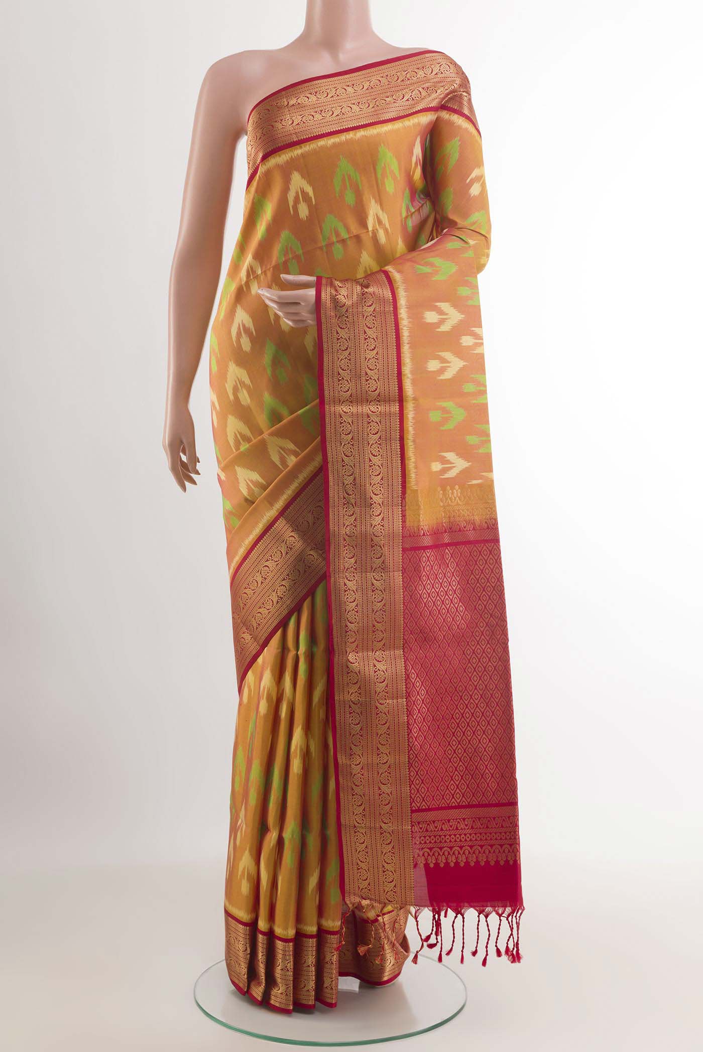 Peach Soft Silk Saree with Ikat design on the body and Zari Border.  displayed on a mannequin