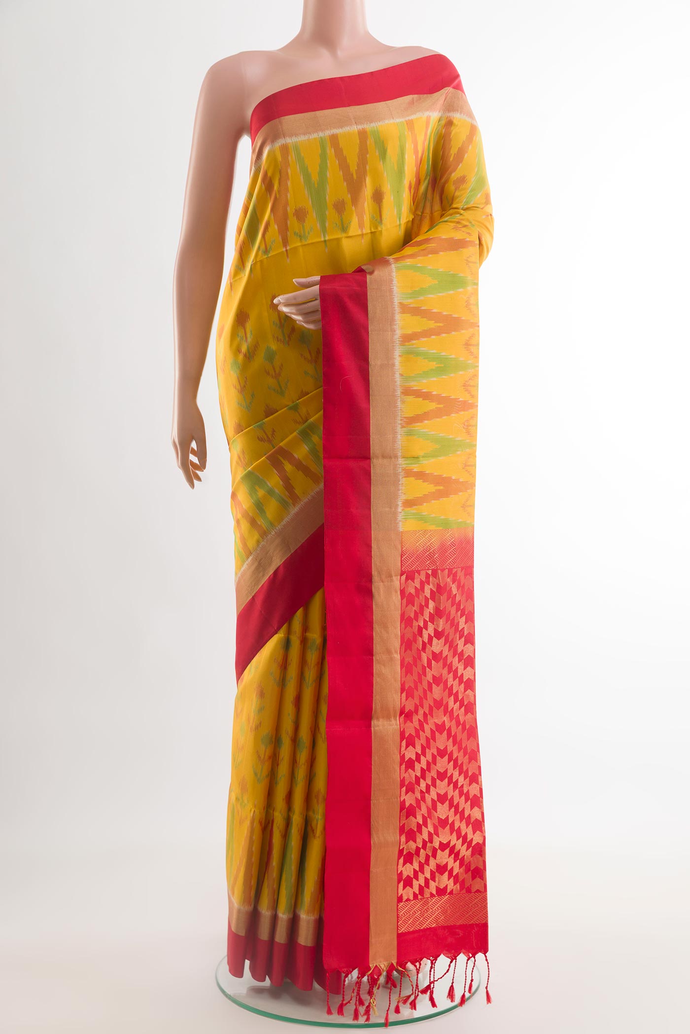 Yellow Soft Silk Saree with Ikat design on the body and Zari Border.  displayed on a mannequin