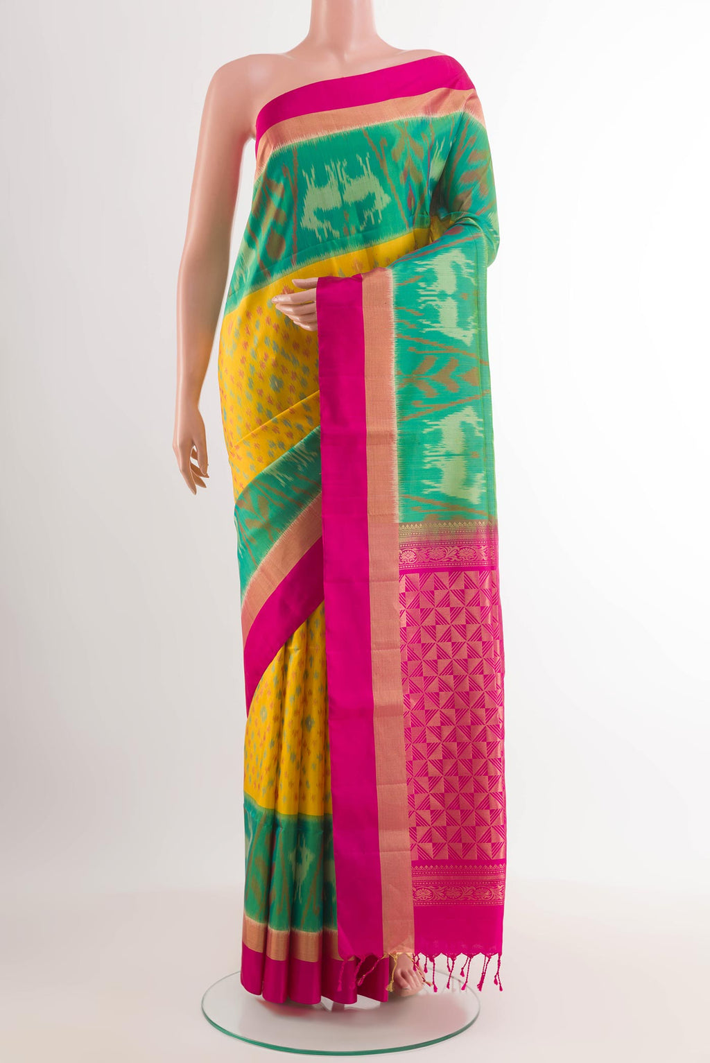 Yellow Soft Silk Saree with Ikat design on the body and Zari Border.  displayed on a mannequin