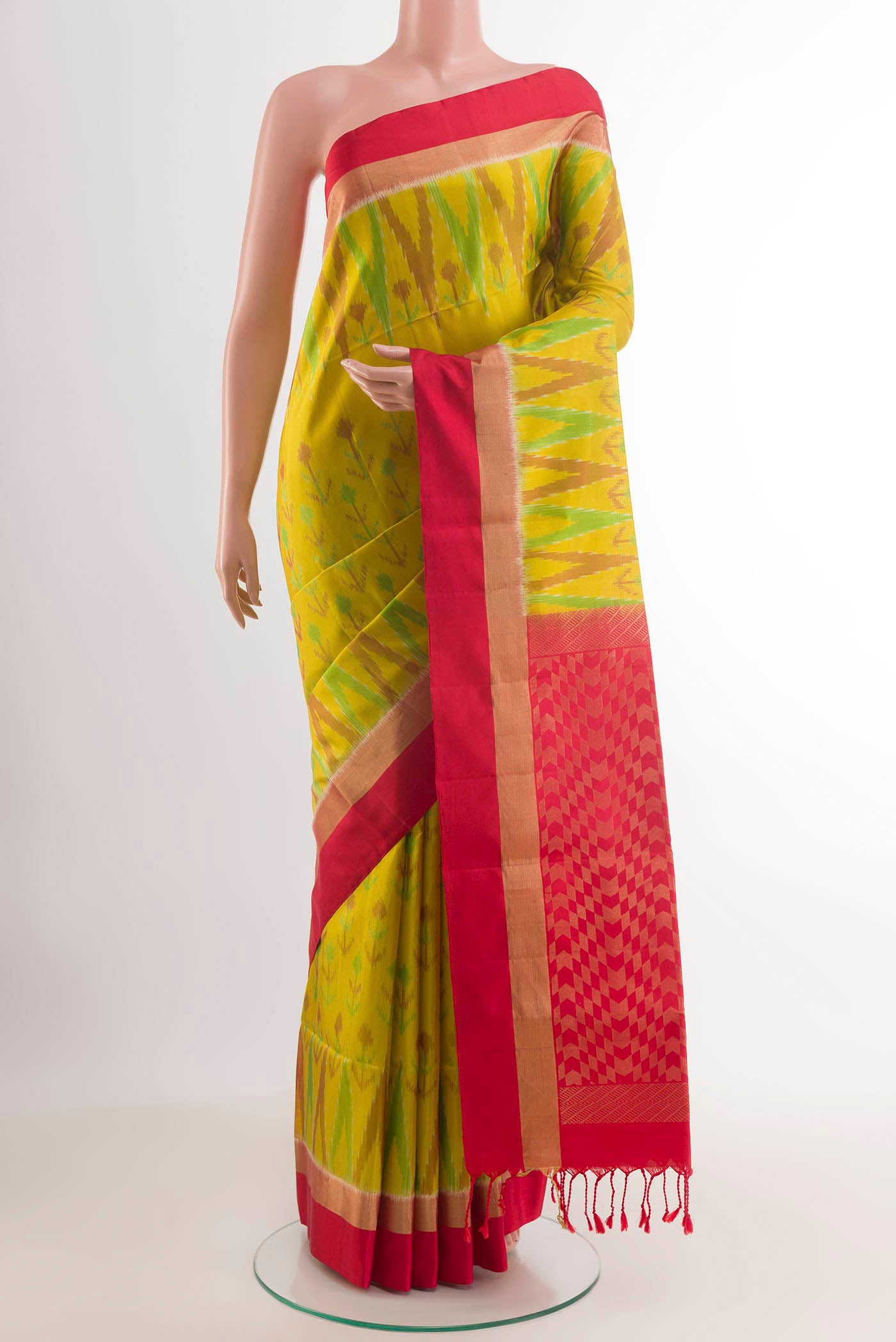 Yellow Soft Silk Saree with Ikat design on the body and Zari Border.  displayed on a mannequin