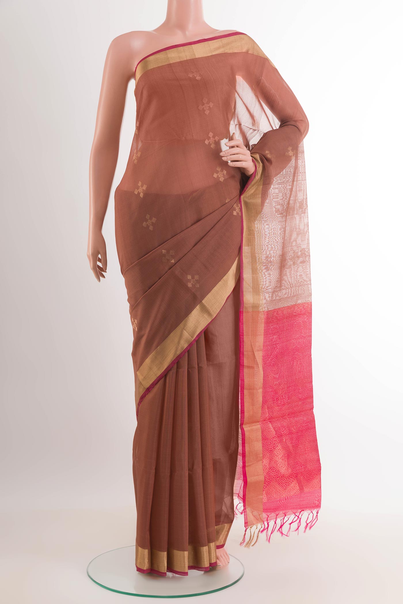 Brown Blended Kora Cotton Saree with Zari Butta on the body and Zari Border.  displayed on a mannequin