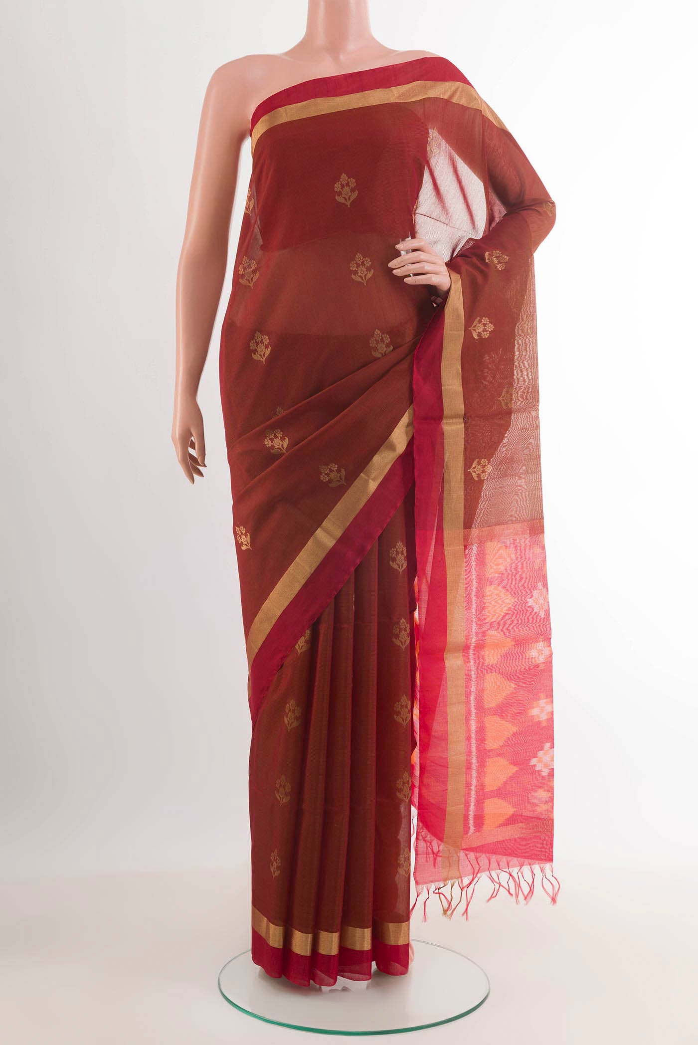 Maroon Blended Kora Cotton Saree with Zari Butta on the body and Zari Border.  displayed on a mannequin