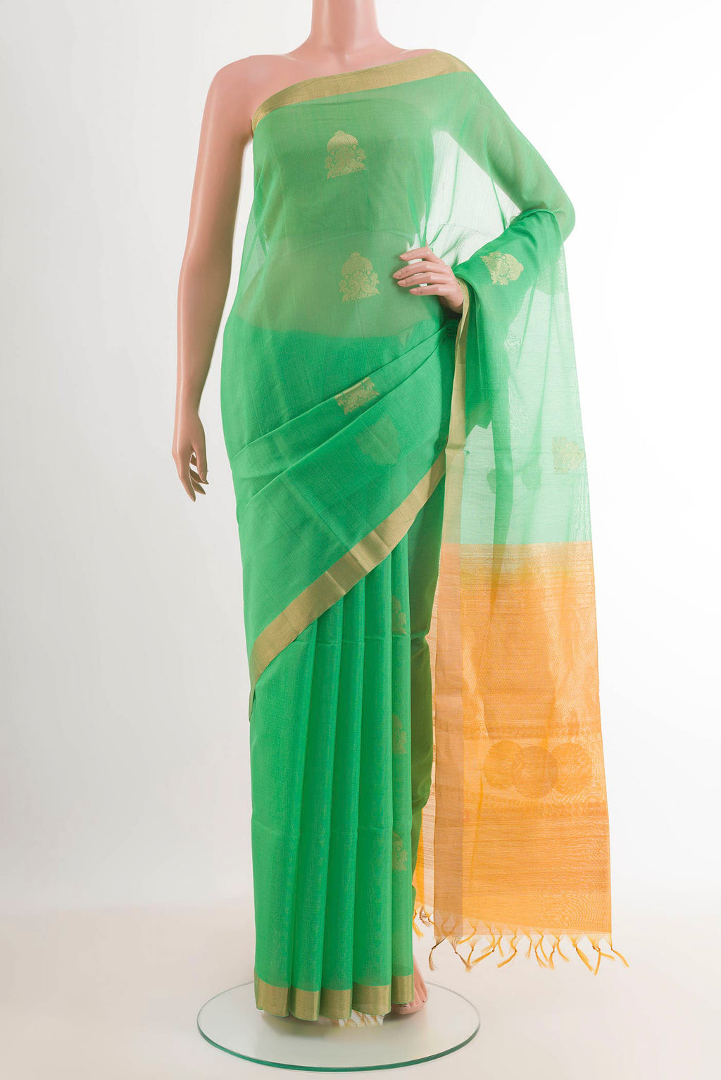 Green Blended Kora Cotton Saree with Zari Butta on the body and Zari Border.  displayed on a mannequin