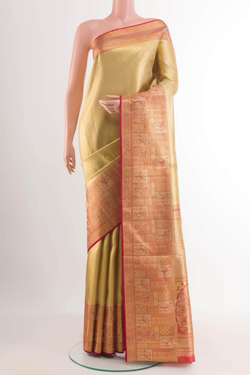 Golden Kanchipuram Silk Saree with Zari Brocade on the body and Plain Border.  displayed on a mannequin