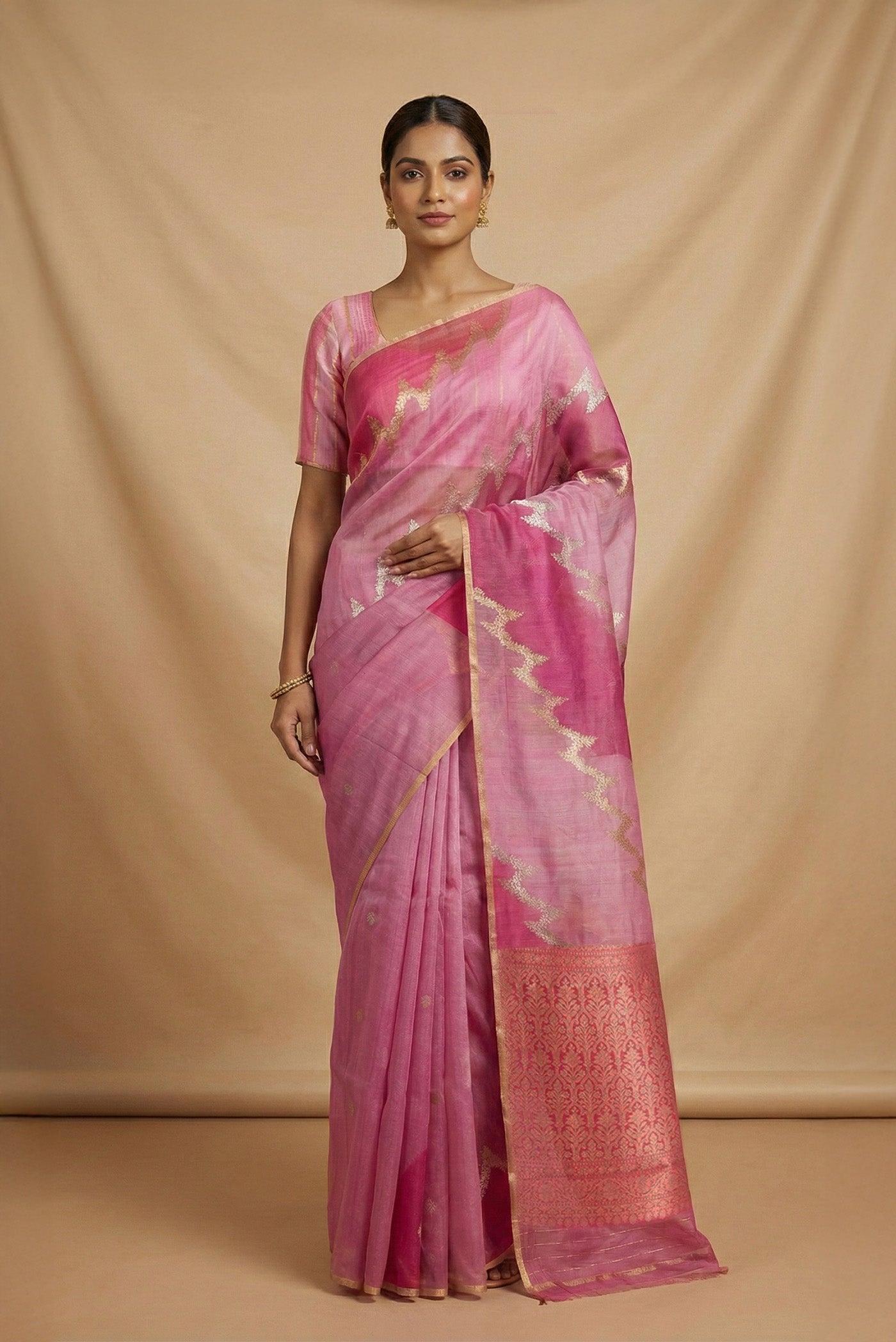 Model wearing a Rose pink Banarasi Kora Silk Saree with Zari Butta on the body and Zari Border.
