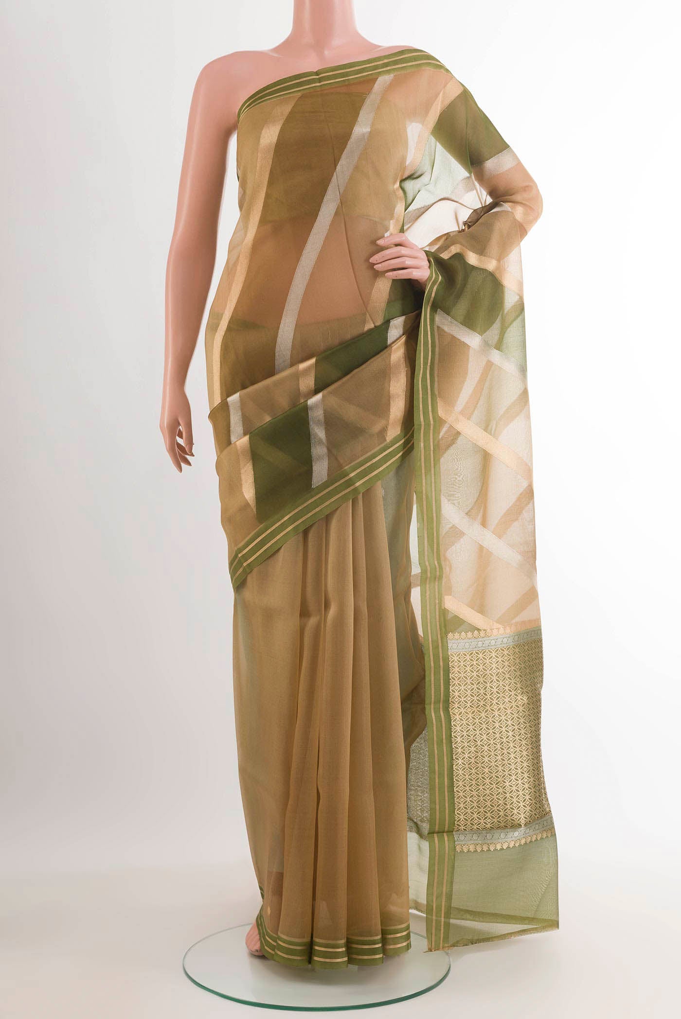 Green Banarasi Kora Silk Saree with Zari Butta on the body and Zari Border.  displayed on a mannequin