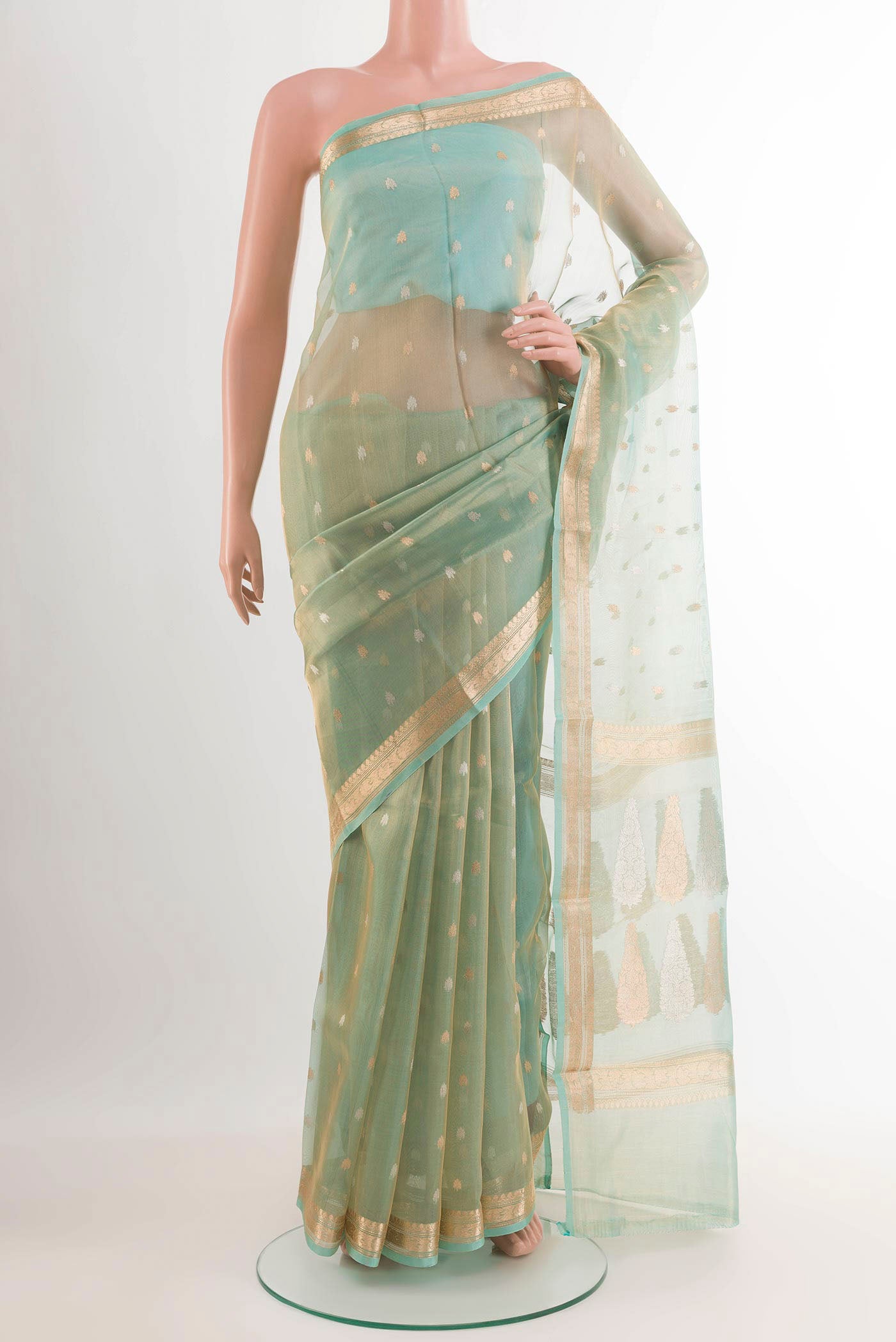 Blue Banarasi Kora Silk Saree with Zari Butta on the body and Zari Border.  displayed on a mannequin