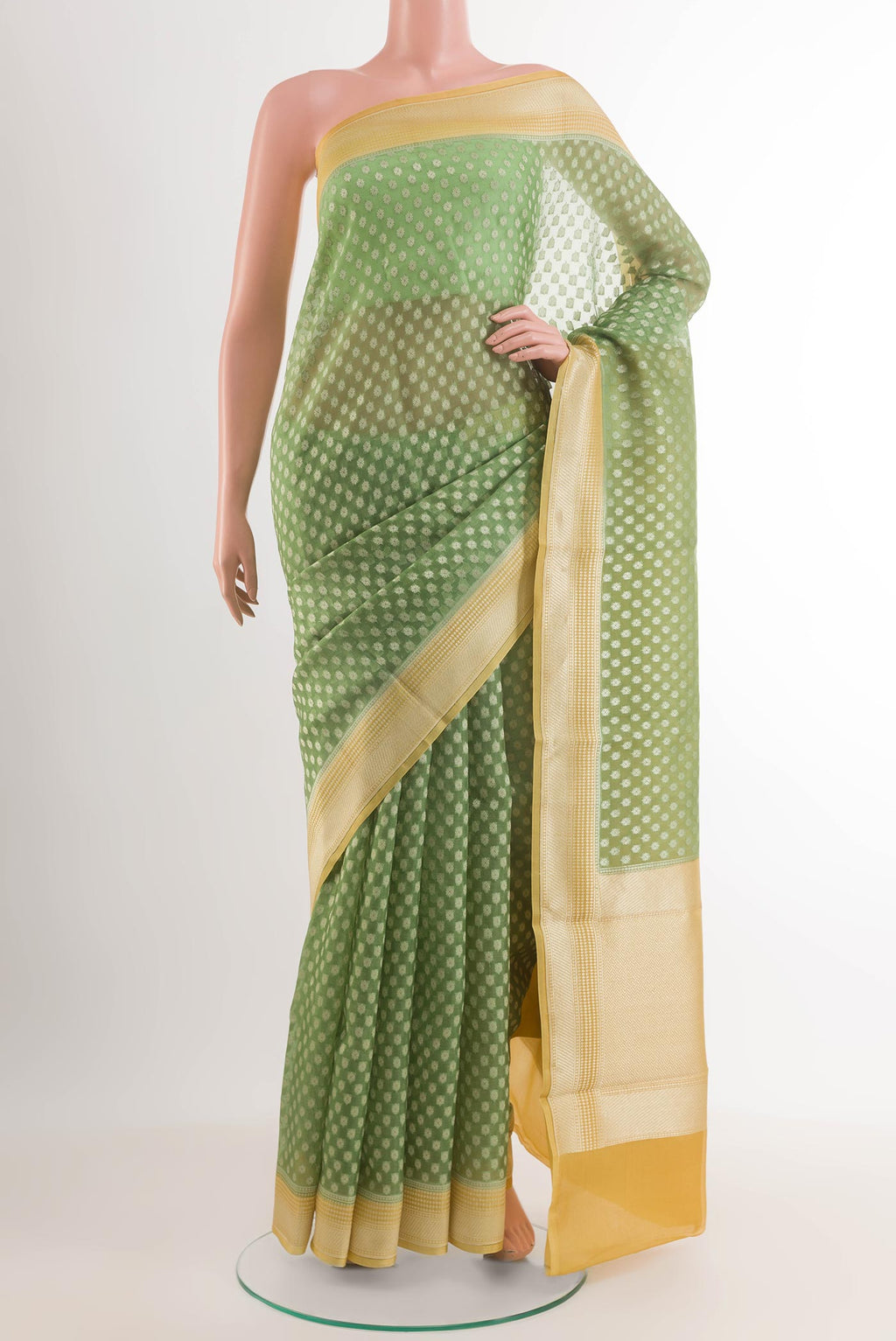 Green Banarasi Kora Silk Saree with Zari Butta on the body and Zari Border.  displayed on a mannequin