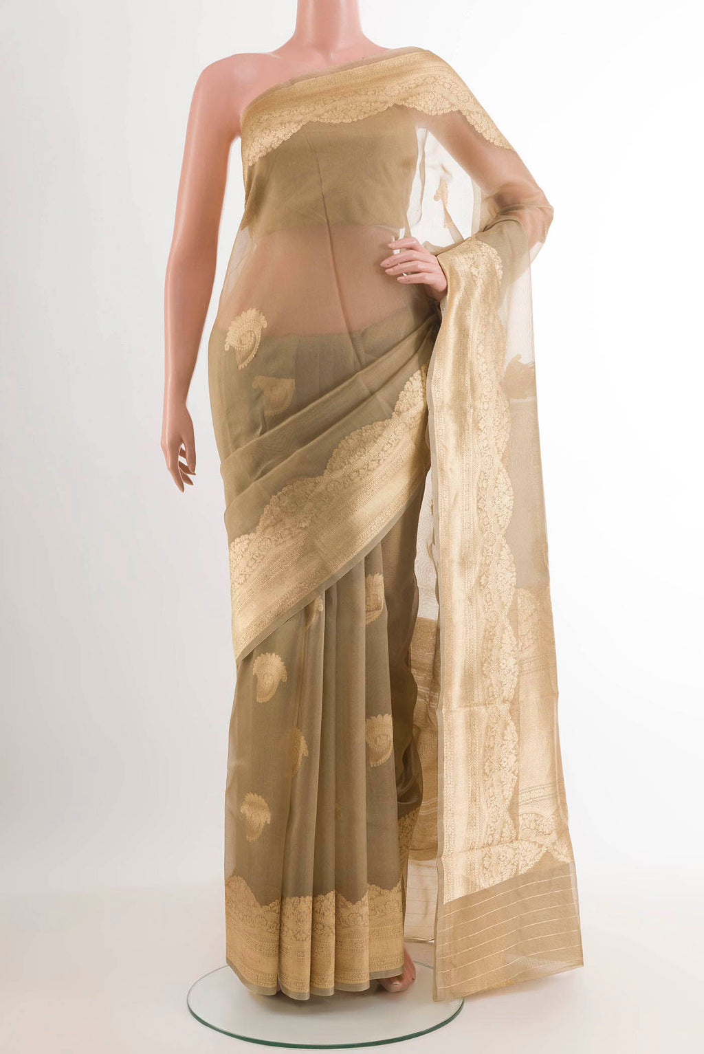 Beige Banarasi Kora Silk Saree with Zari Butta on the body and Zari Border.  displayed on a mannequin