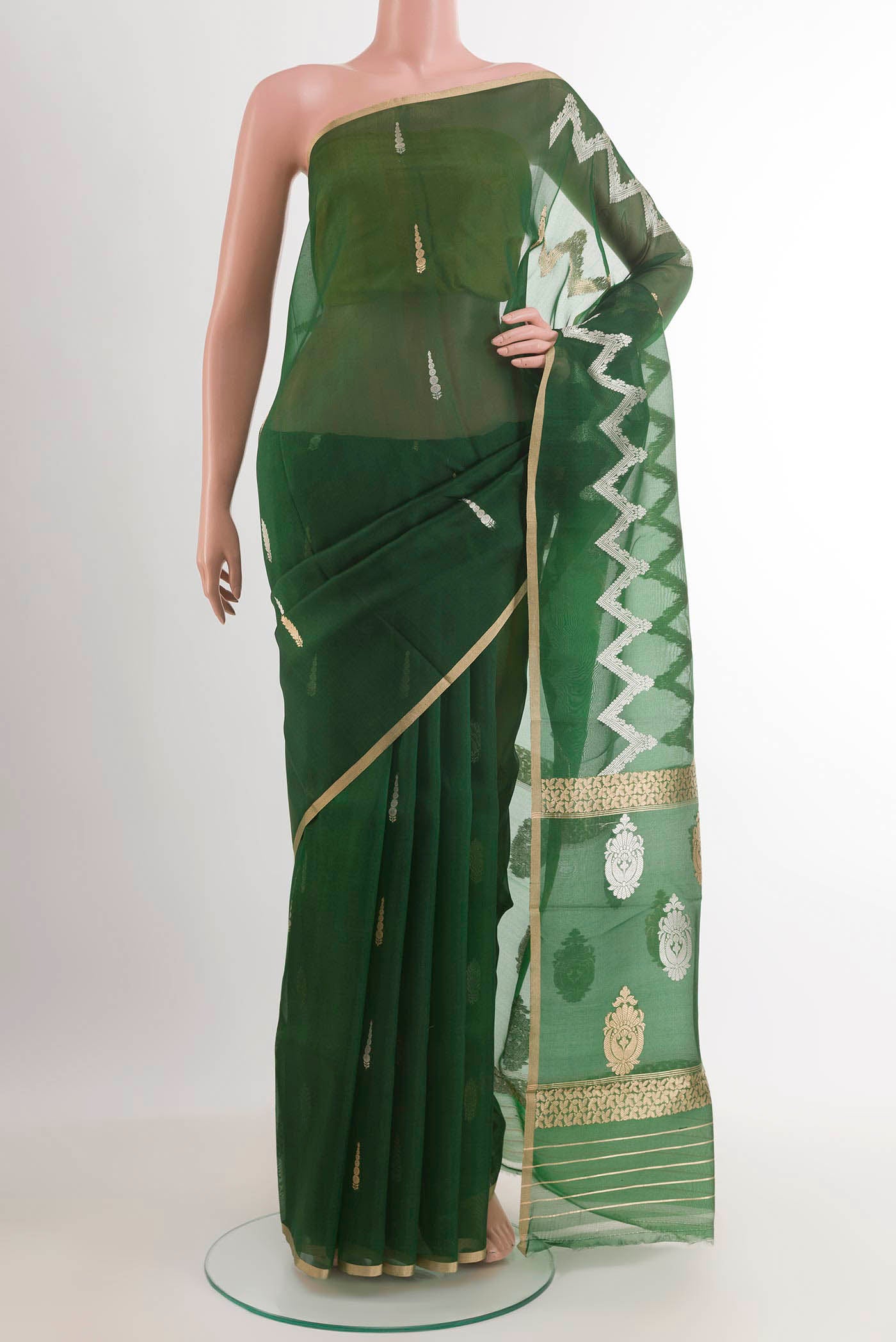 Green Banarasi Kora Silk Saree with Zari Butta on the body and Plain Border.  displayed on a mannequin