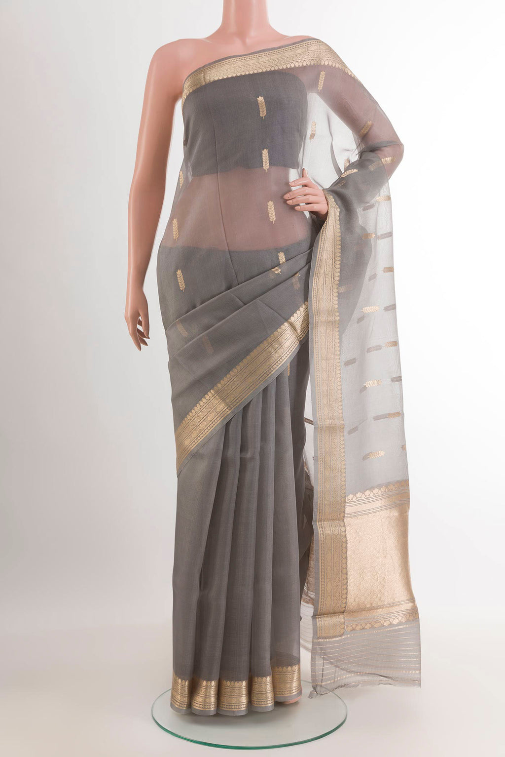 Grey Banarasi Kora Silk Saree with Zari Butta on the body and Zari Border.  displayed on a mannequin