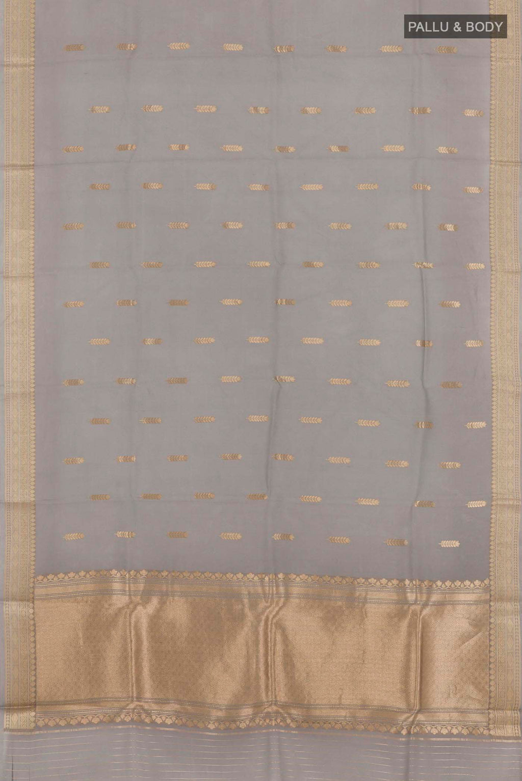 Flat view of Grey Banarasi Kora Silk Saree with Zari Butta on the body and Zari Border. 