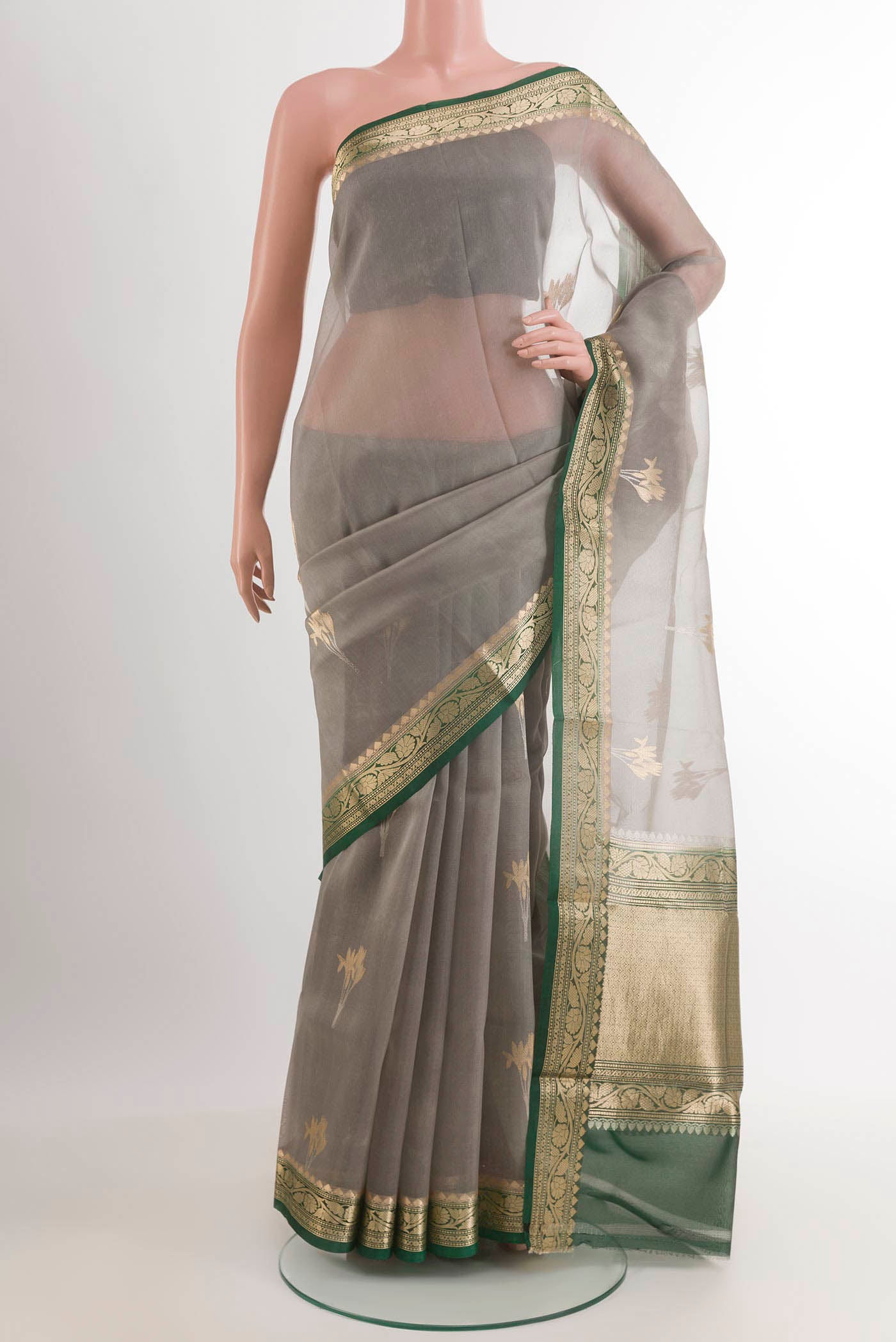 Grey Banarasi Kora Silk Saree with Zari Butta on the body and Zari Border.  displayed on a mannequin