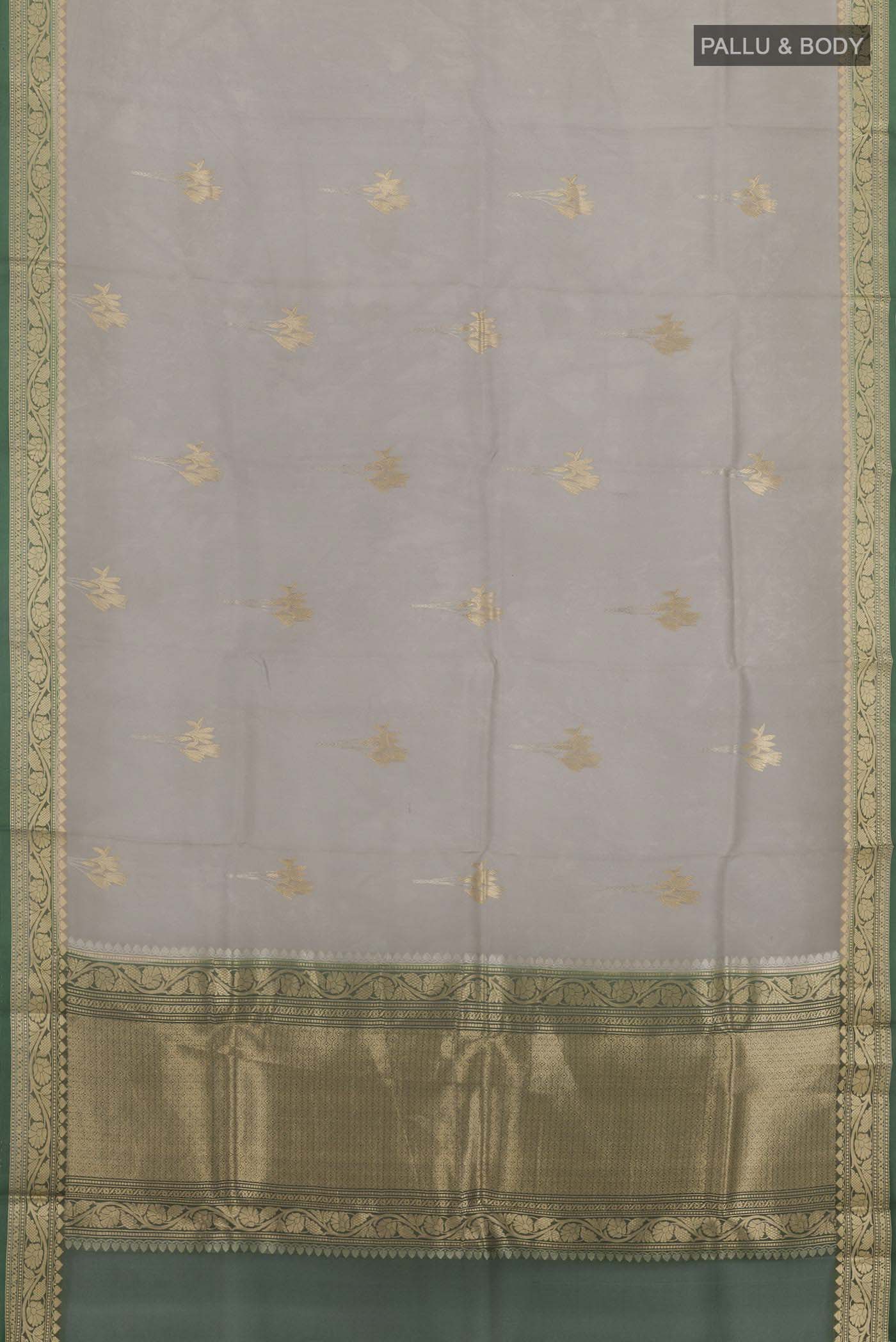 Flat view of Grey Banarasi Kora Silk Saree with Zari Butta on the body and Zari Border. 