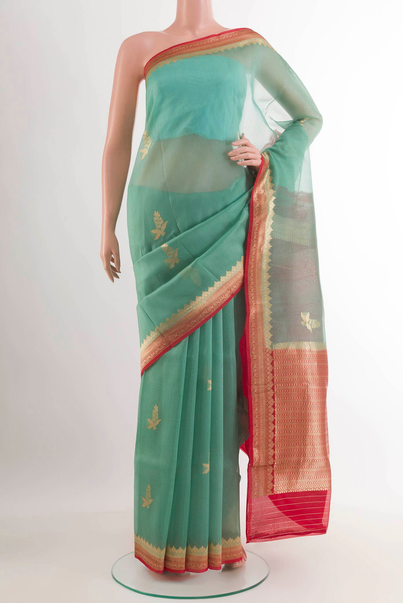 Turquoise Banarasi Kora Silk Saree with Zari Butta on the body and Zari Border.  displayed on a mannequin
