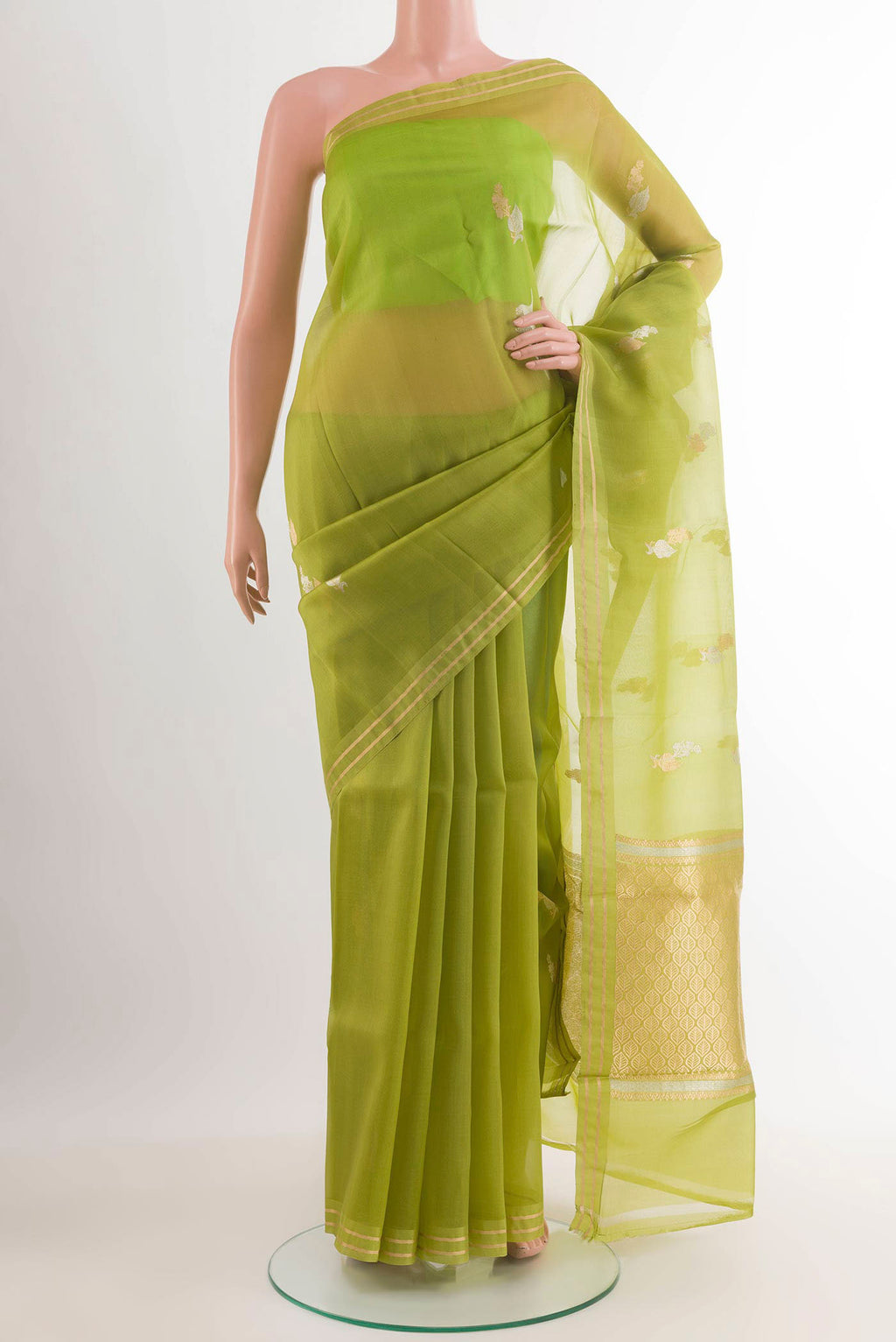 Green Banarasi Kora Silk Saree with Zari Butta on the body and Zari Border.  displayed on a mannequin