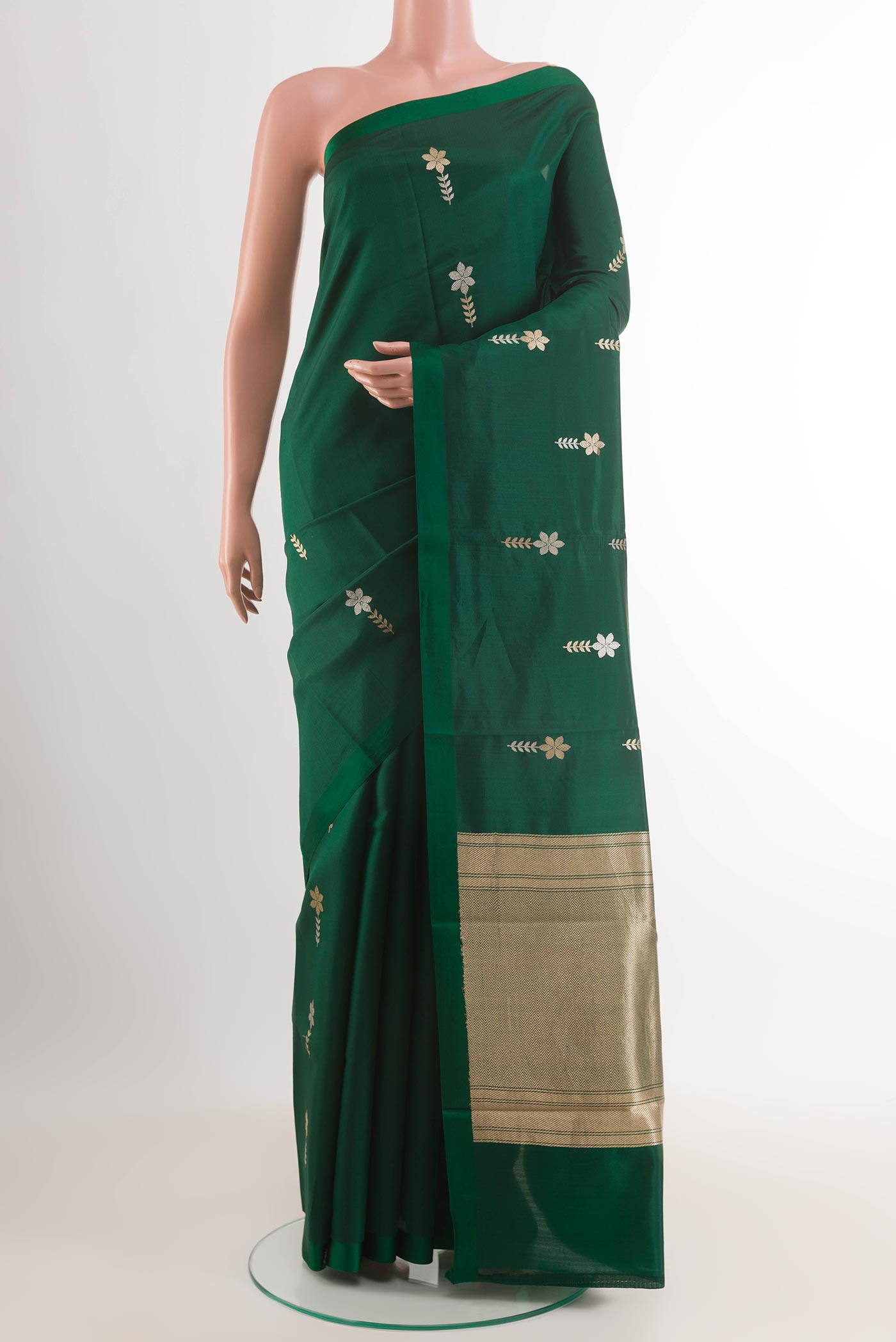 Green Banarasi Katan Silk Saree with Zari Butta on the body and Plain Border.  displayed on a mannequin