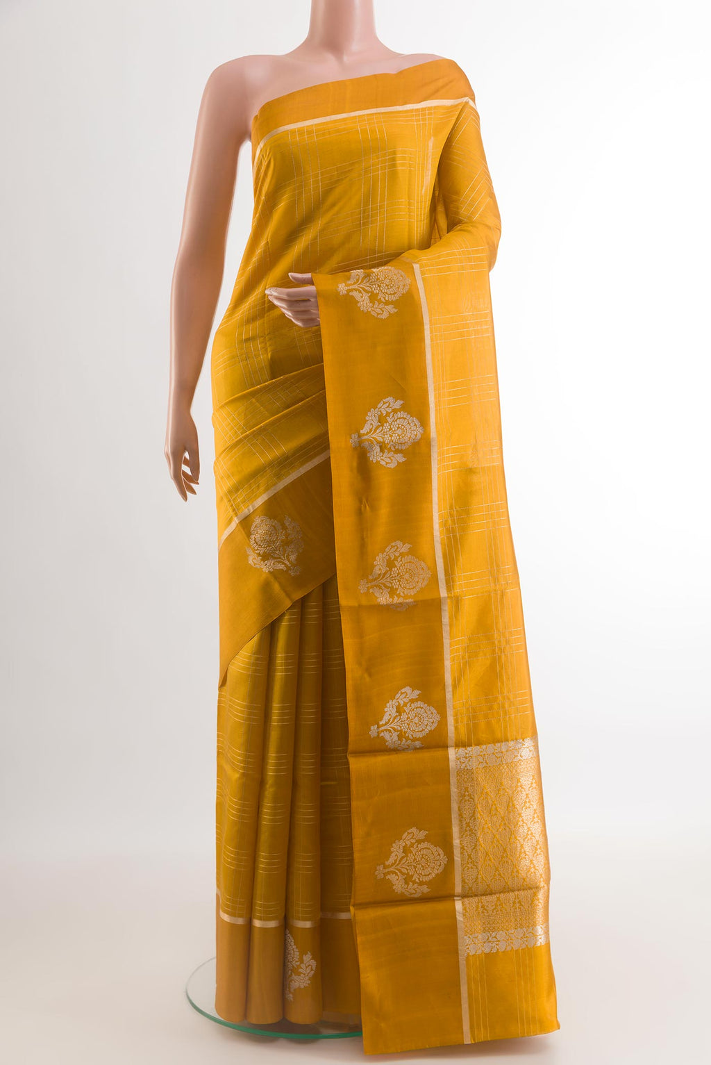 Mustard Banarasi Katan Silk Saree with Checked design on the body and Zari Border.  displayed on a mannequin