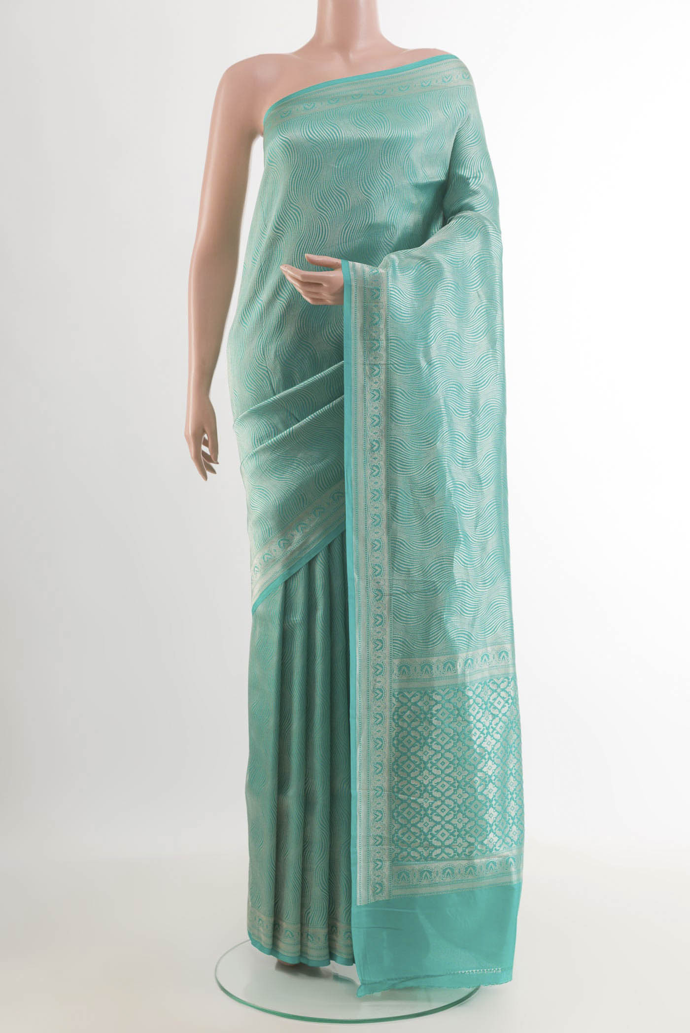 Blue Crepe Saree with Zari Brocade on the body and Zari Border.  displayed on a mannequin