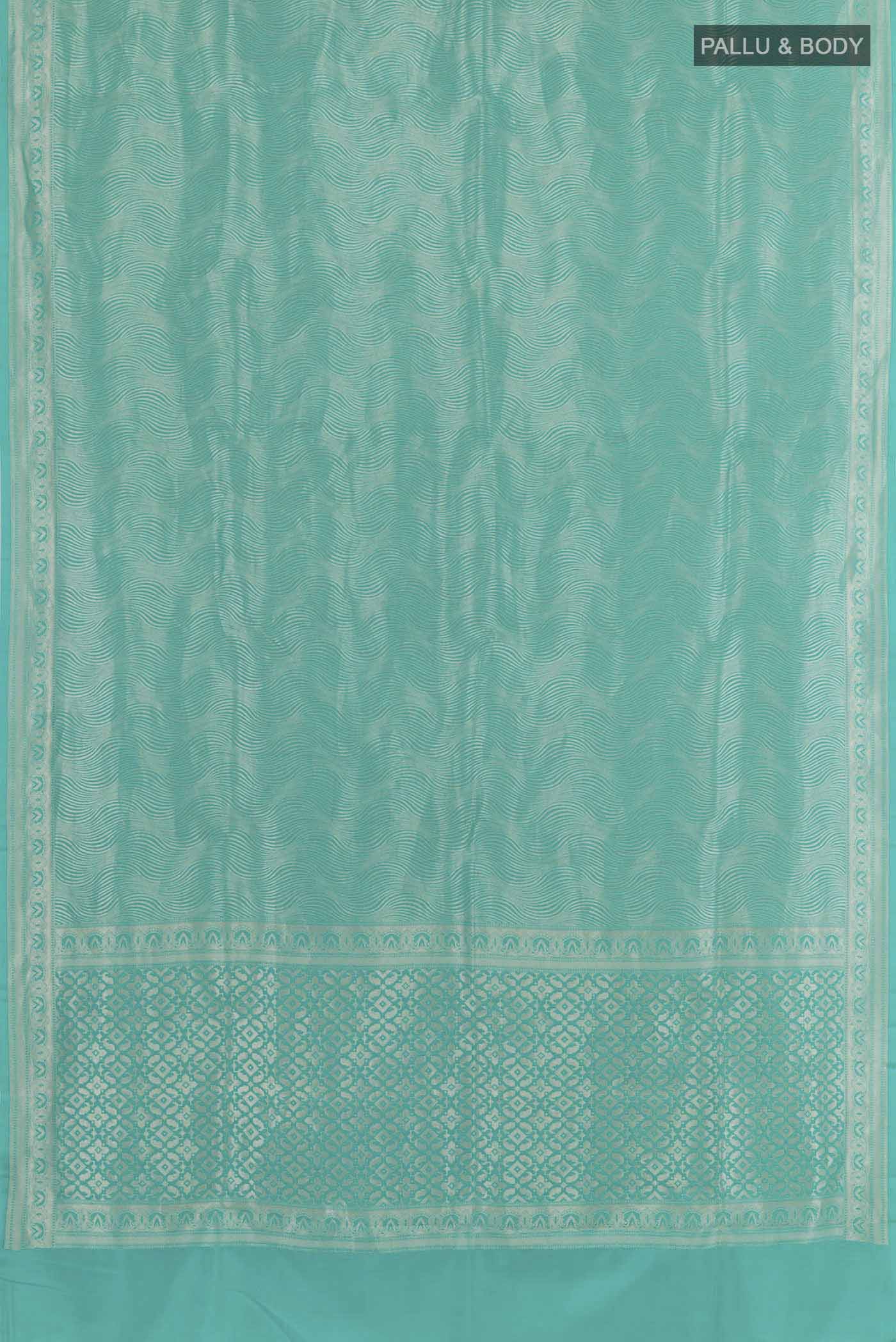 Flat view of Blue Crepe Saree with Zari Brocade on the body and Zari Border. 