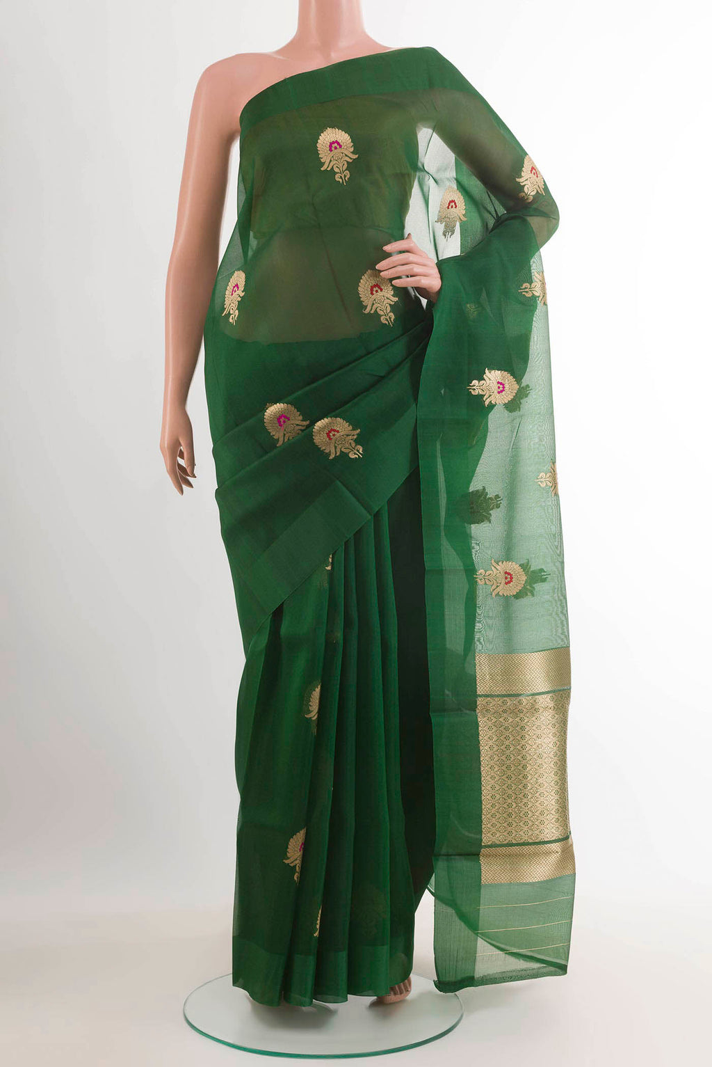 Green Banarasi Kora Silk Saree with Zari Butta on the body and Zari Border.  displayed on a mannequin