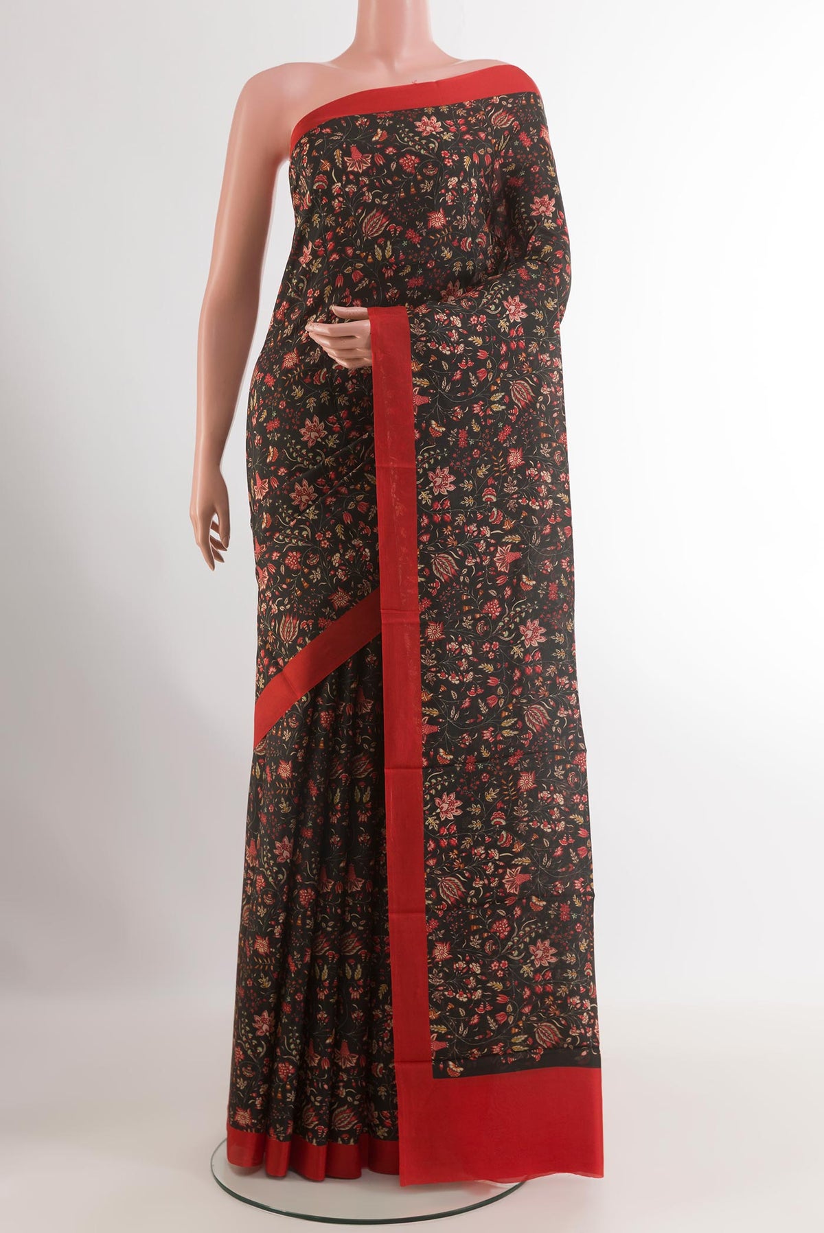 Black Printed Silk Saree with Printed design on the body and Printed Border.  displayed on a mannequin